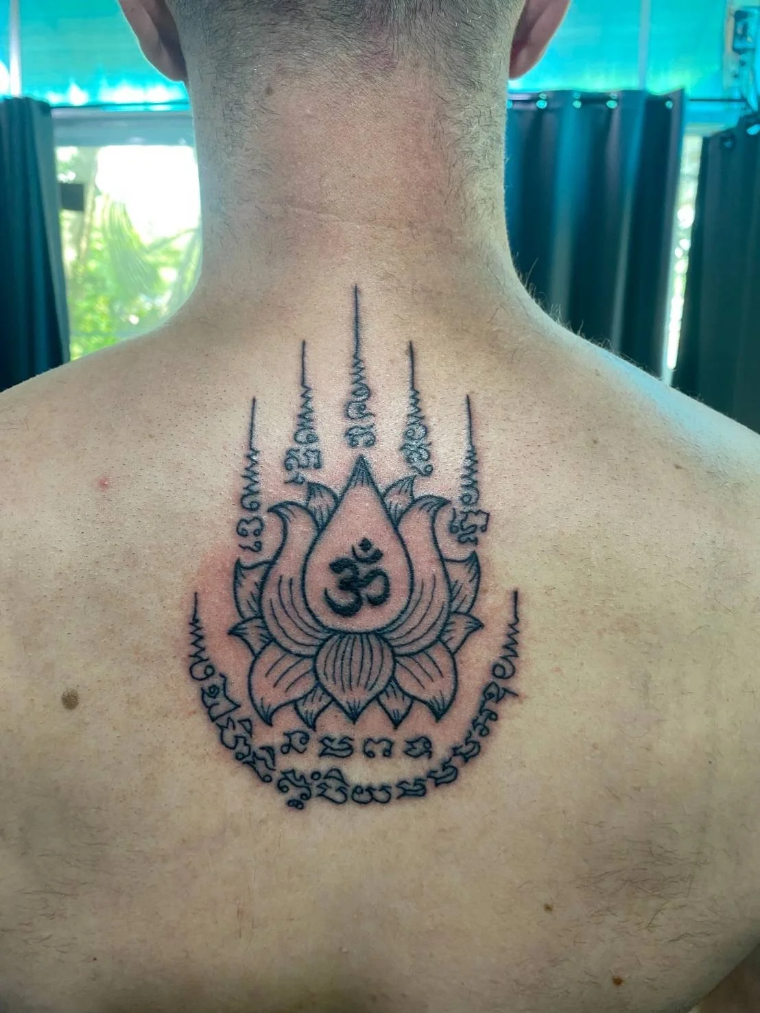 traditional Lotus flower sak yant on a male