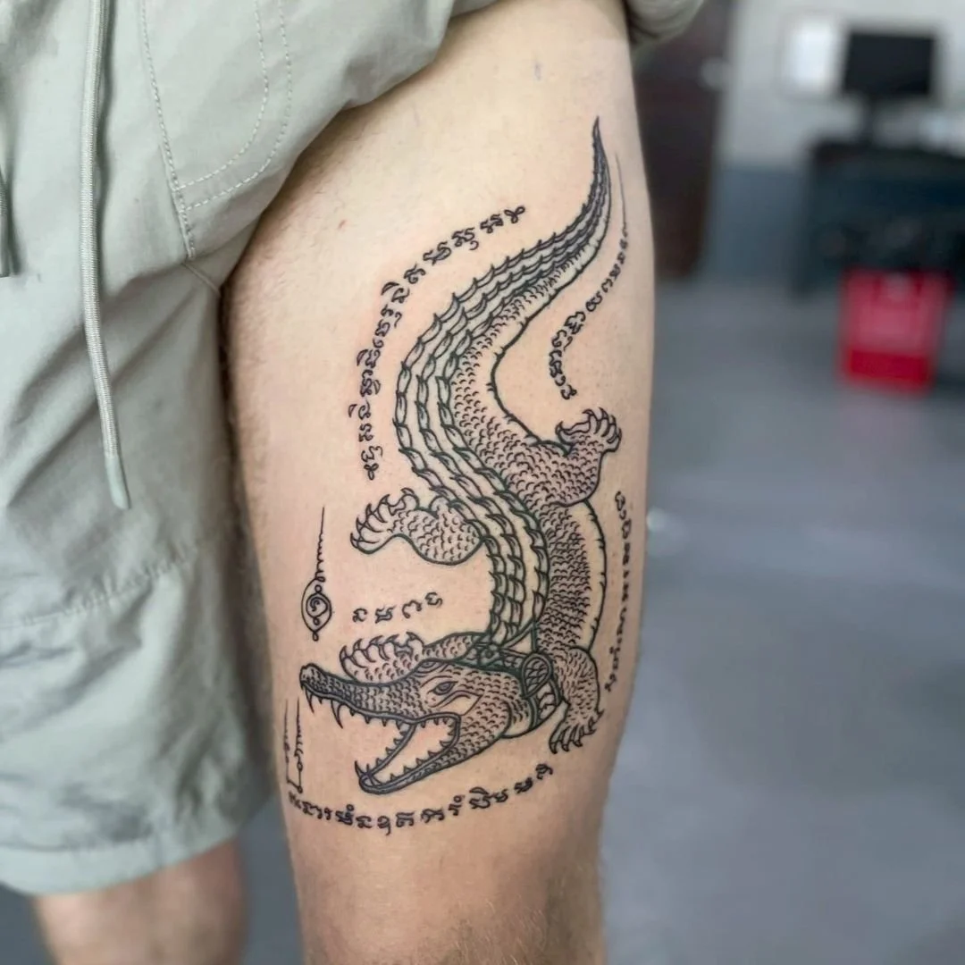 crocodile sak yant on a mans leg in phuket