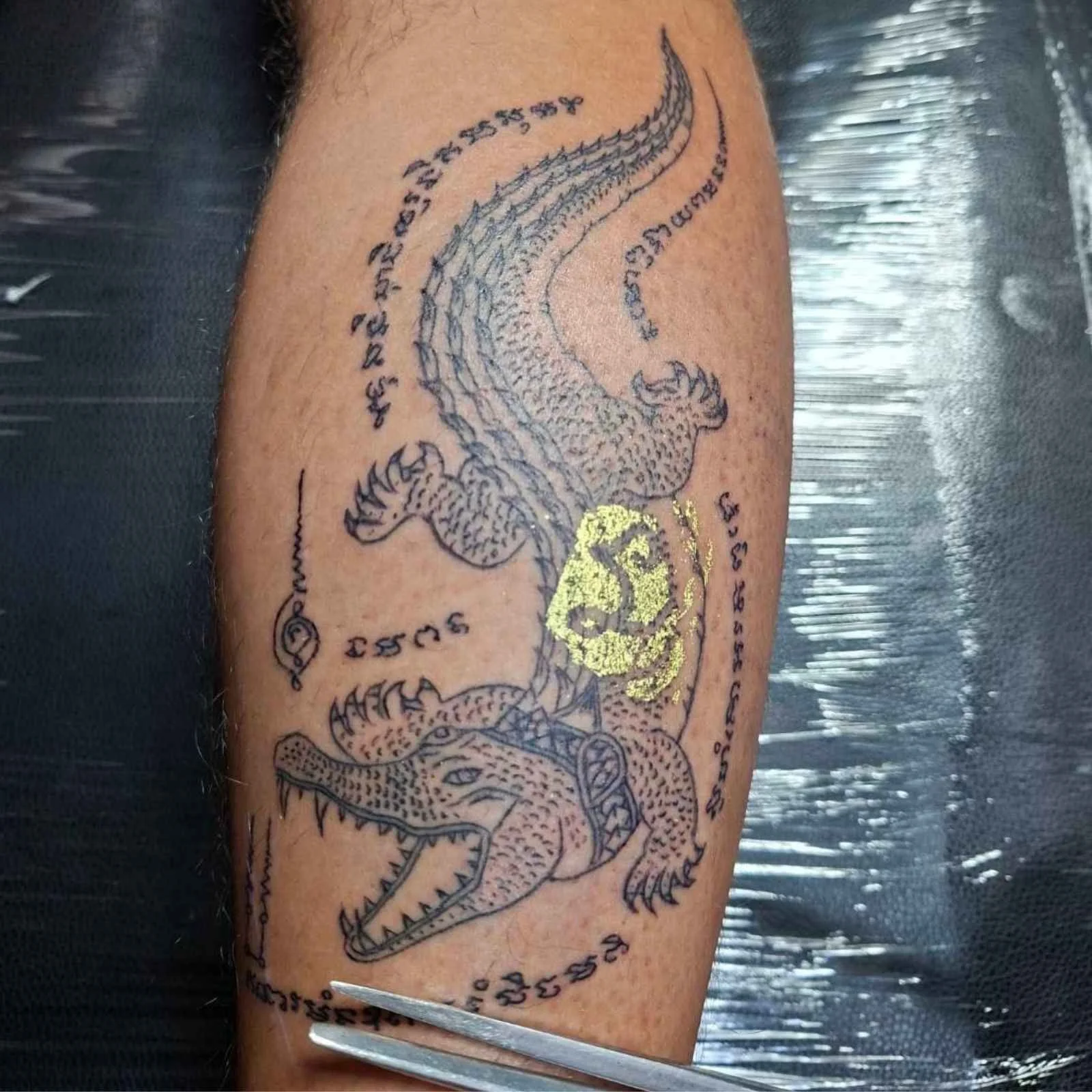 A man with a crocodile sak yant