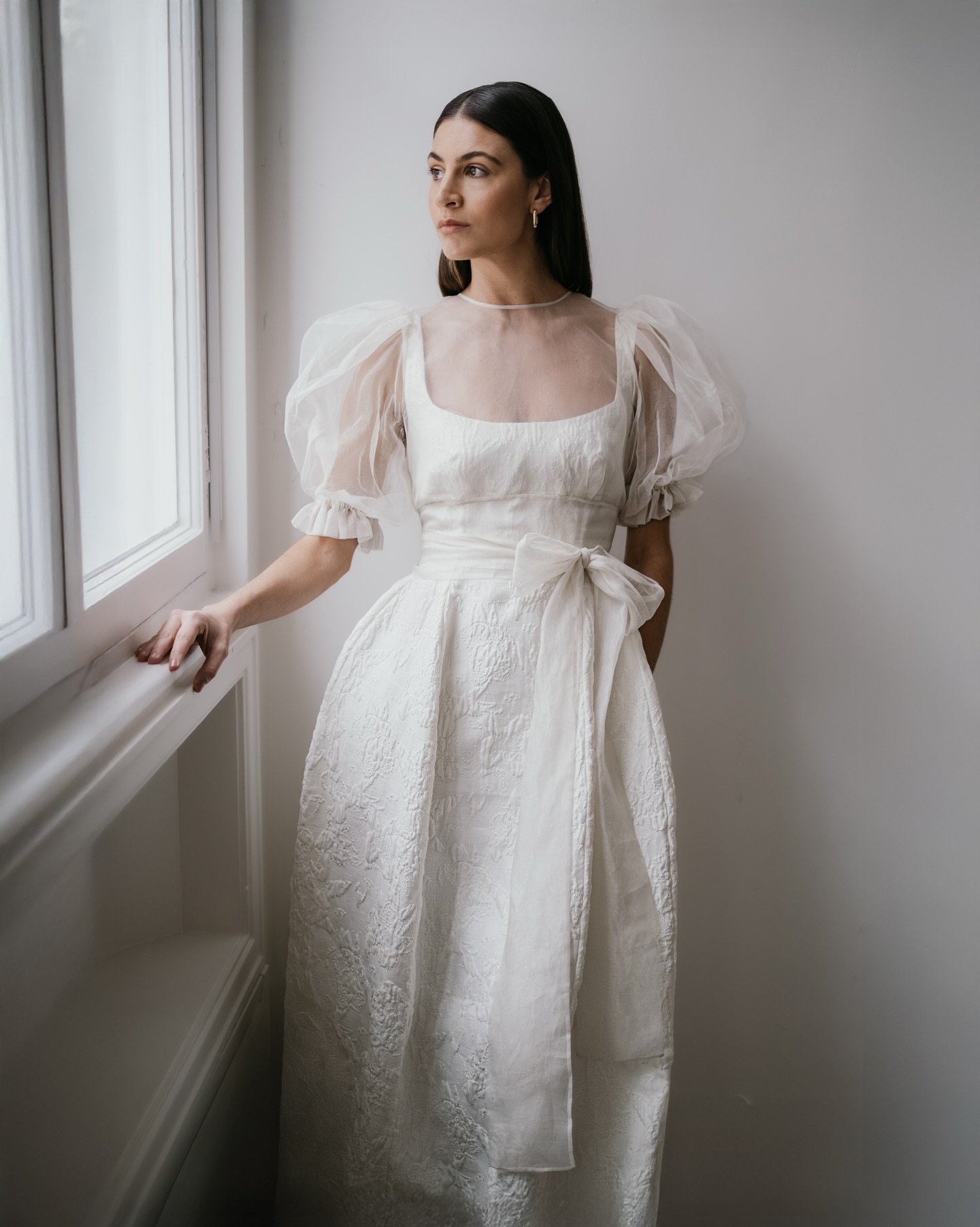THORA + EMMIE.

Architectural lines meet ethereal layering. A sculptural gown in a textured jacquard layered with delicate and sheer silk organza. 

A contemporary bridal look that embraces contrast and soft structure. 

#modernbride #weddingdressins