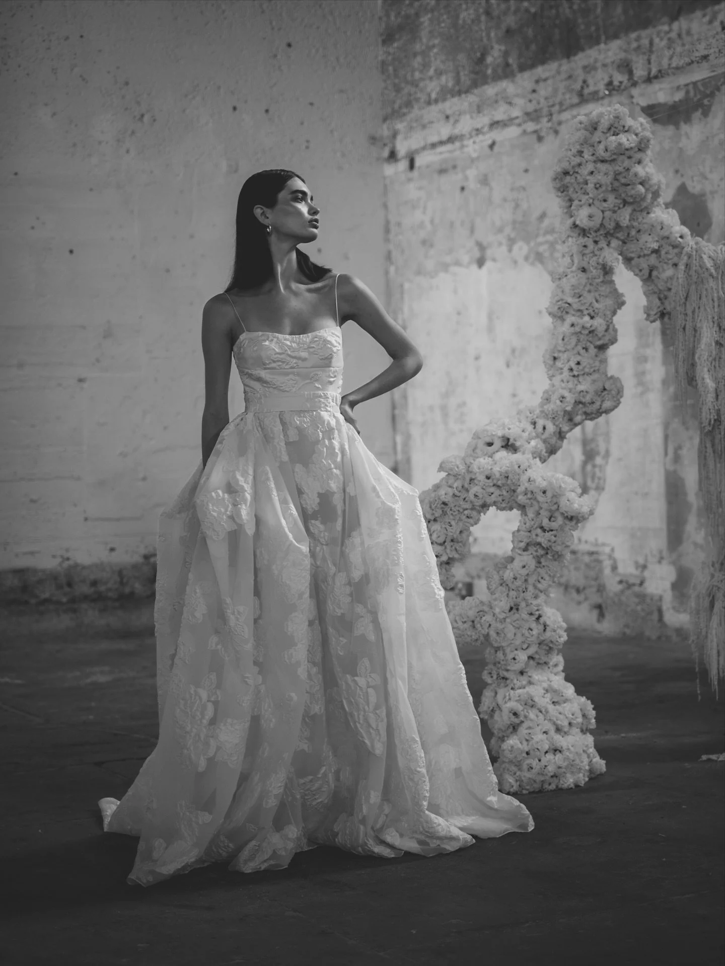 The LISIANTHUS gown and layering skirt. 

Rich folds of textural organza jacquard contrast with a sculpted bodice and delicate shoestring straps. A statement bridal silhouette for the modern bride.

Designed for the UNBRIDLED STUDIO X FIONA FLEUR col