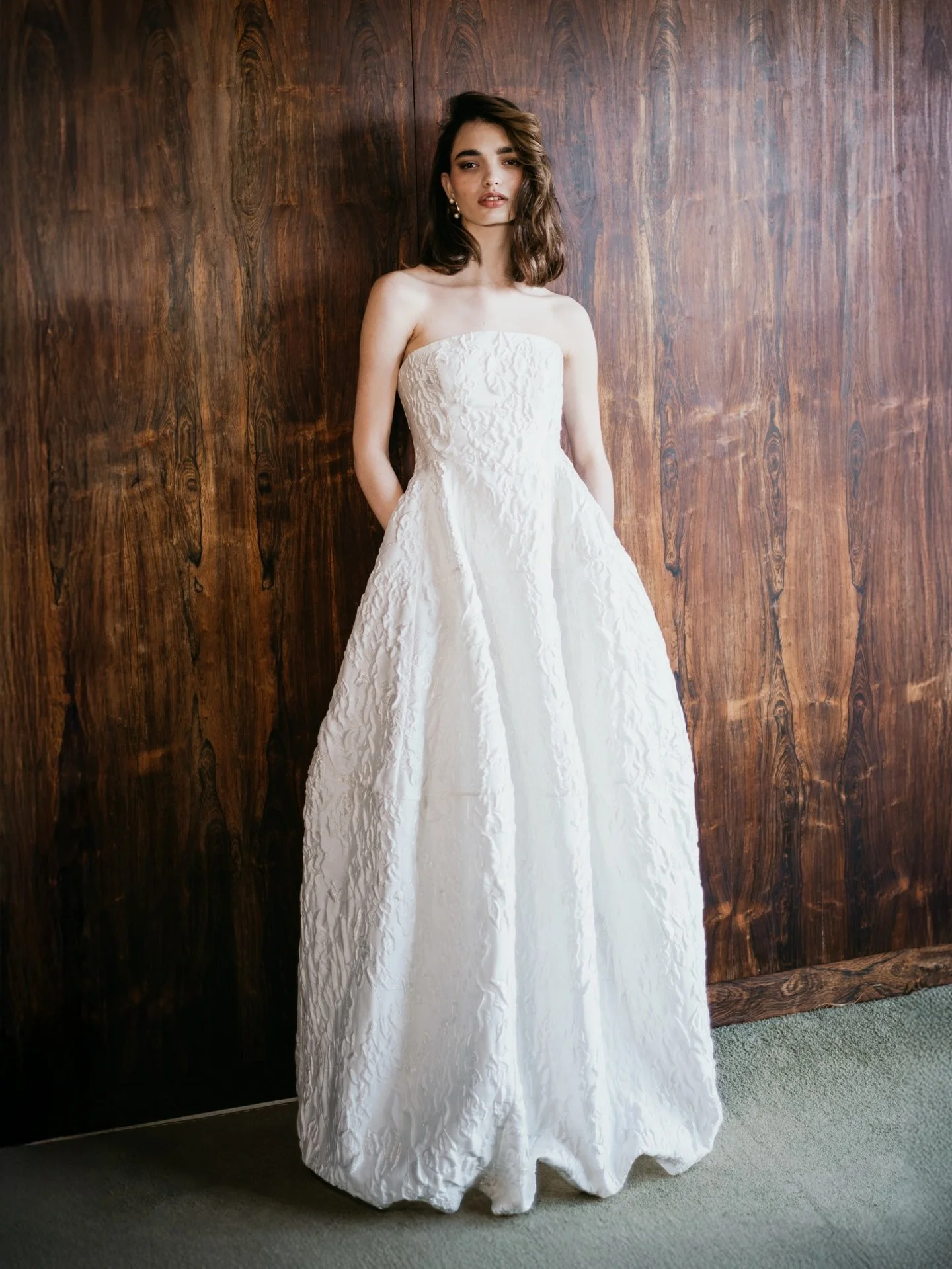 The AUBREY gown and detachable RIVER train. A look that fuses modernity with nostalgic grandeur and our signature balance of contemporary cut and luxe fabrication. Introducing a strapless tulip silhouette crafted in a luxurious textural satin jacquar