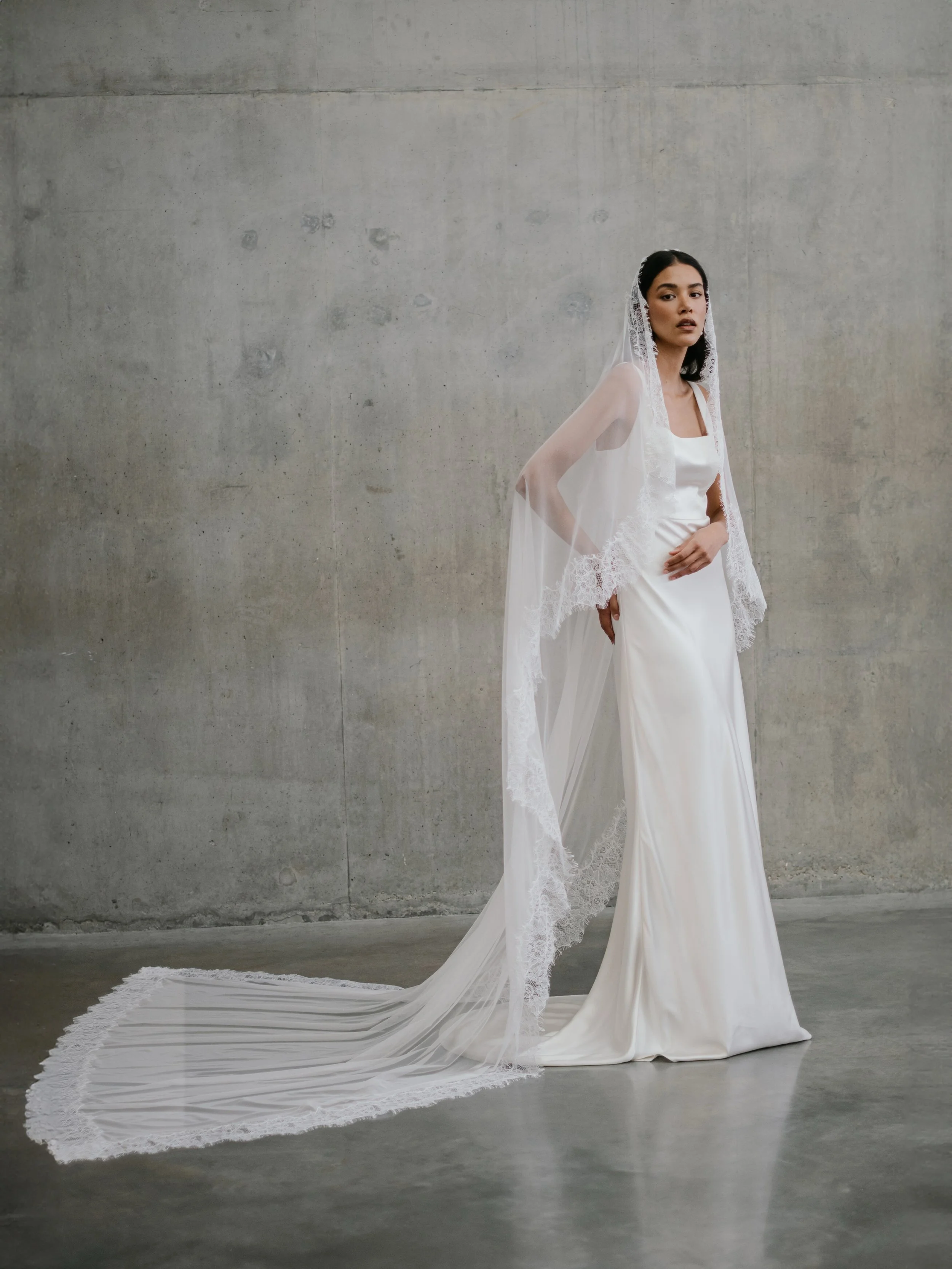 There are few things that are more effortlessly chic in the bridal world than silk satin and delicate lace. Our bias cut CLARA gown and SIENA lace and tulle veil are a lesson in modern romanticism. Luxurious contrasts that perfectly fuse modernity wi