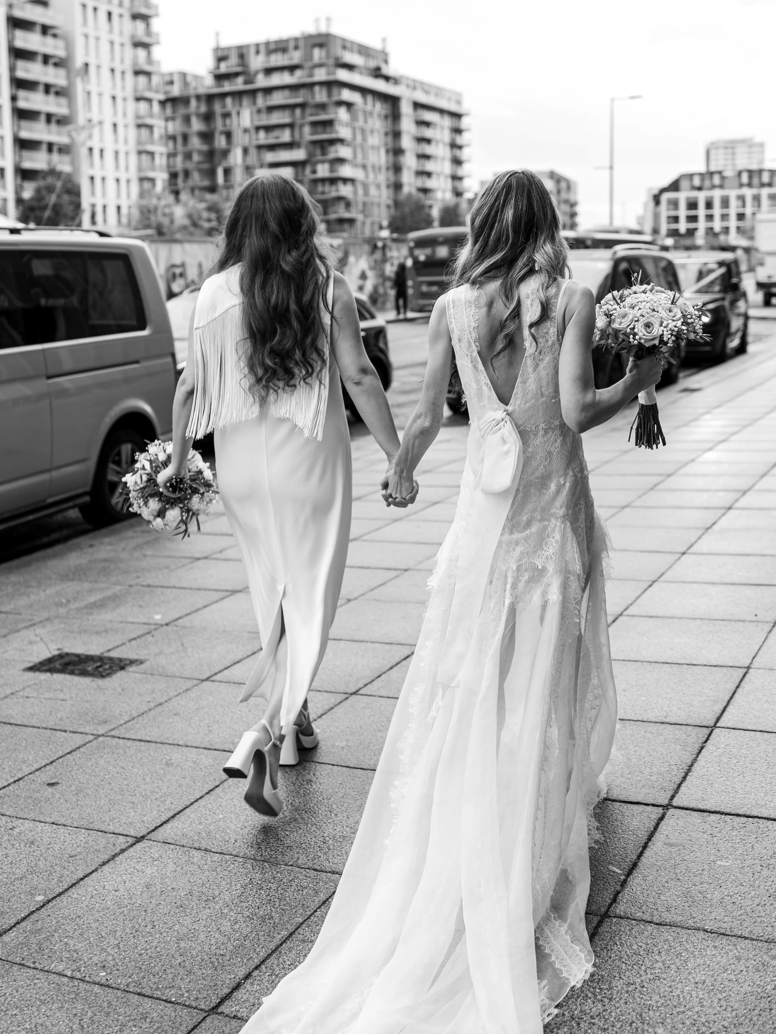 Sarah came to the studio earlier this year with a clear vision for her wedding to Amy: a look that was modern, effortless and a little unexpected.

Sarah chose an ethereal silk organza and hand appliqu&eacute;d lace gown. The final look was contempor