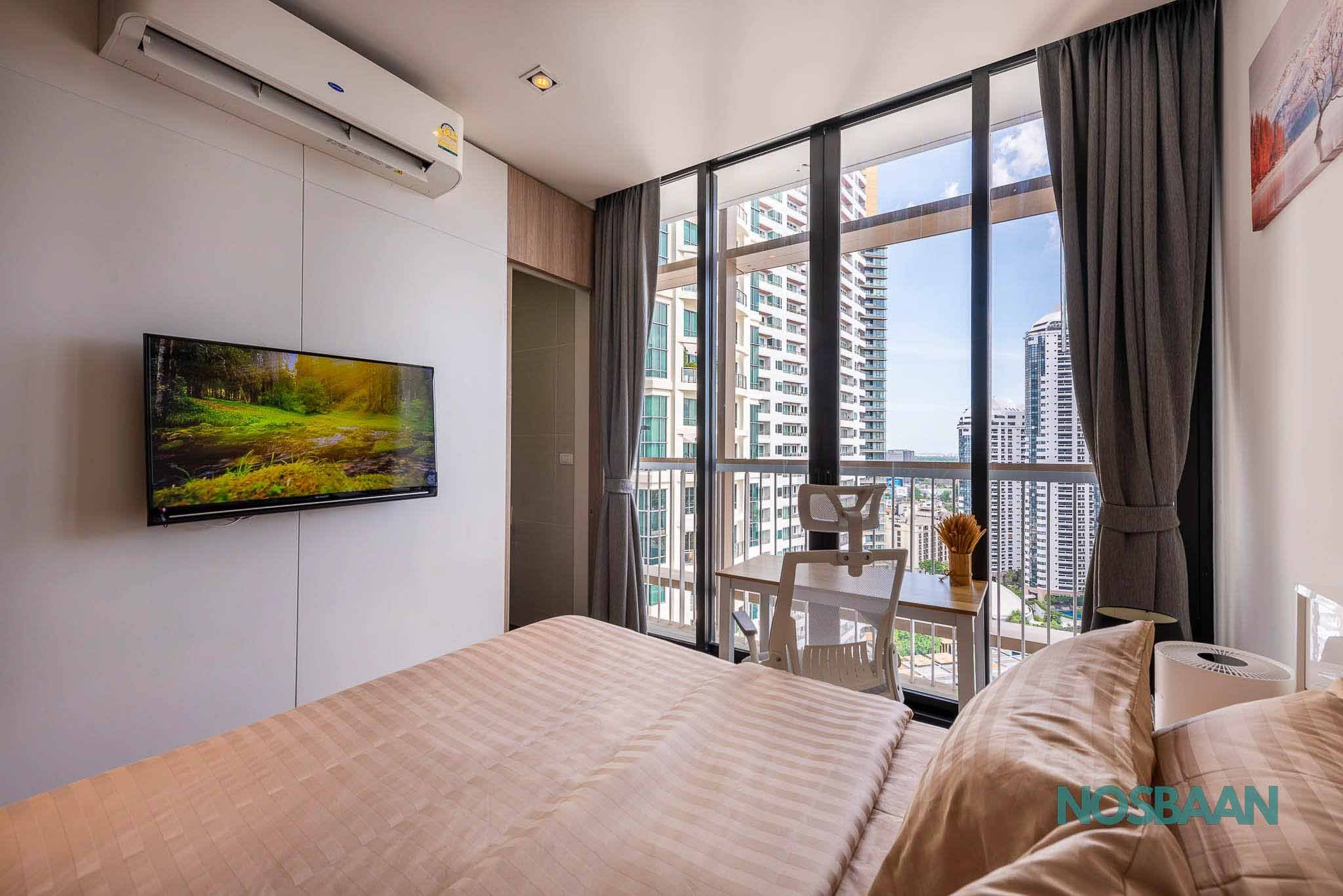 Bright studio apartment featuring contemporary furniture and a small work desk.