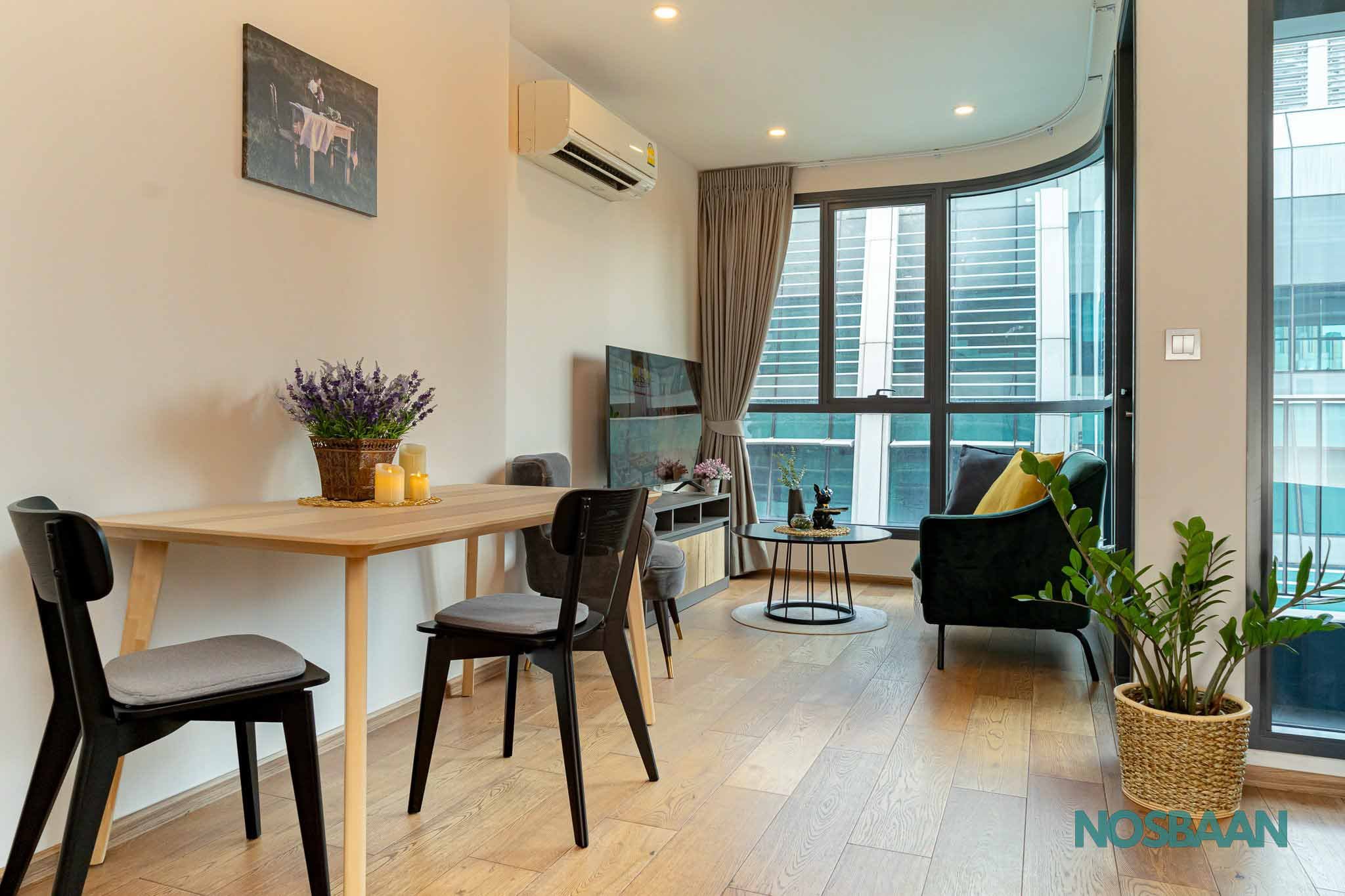 Compact studio unit designed for urban living with a stylish kitchen and work corner.