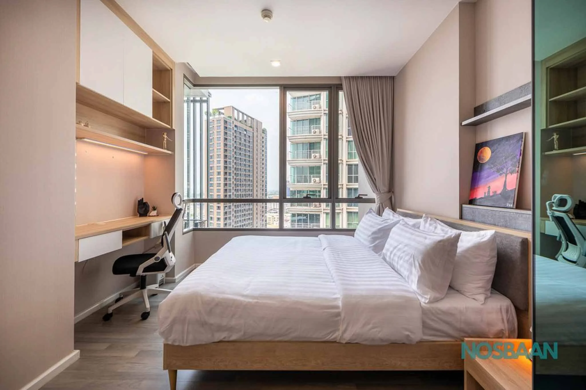 Minimalist studio with a cozy sleeping area and fully furnished kitchenette.