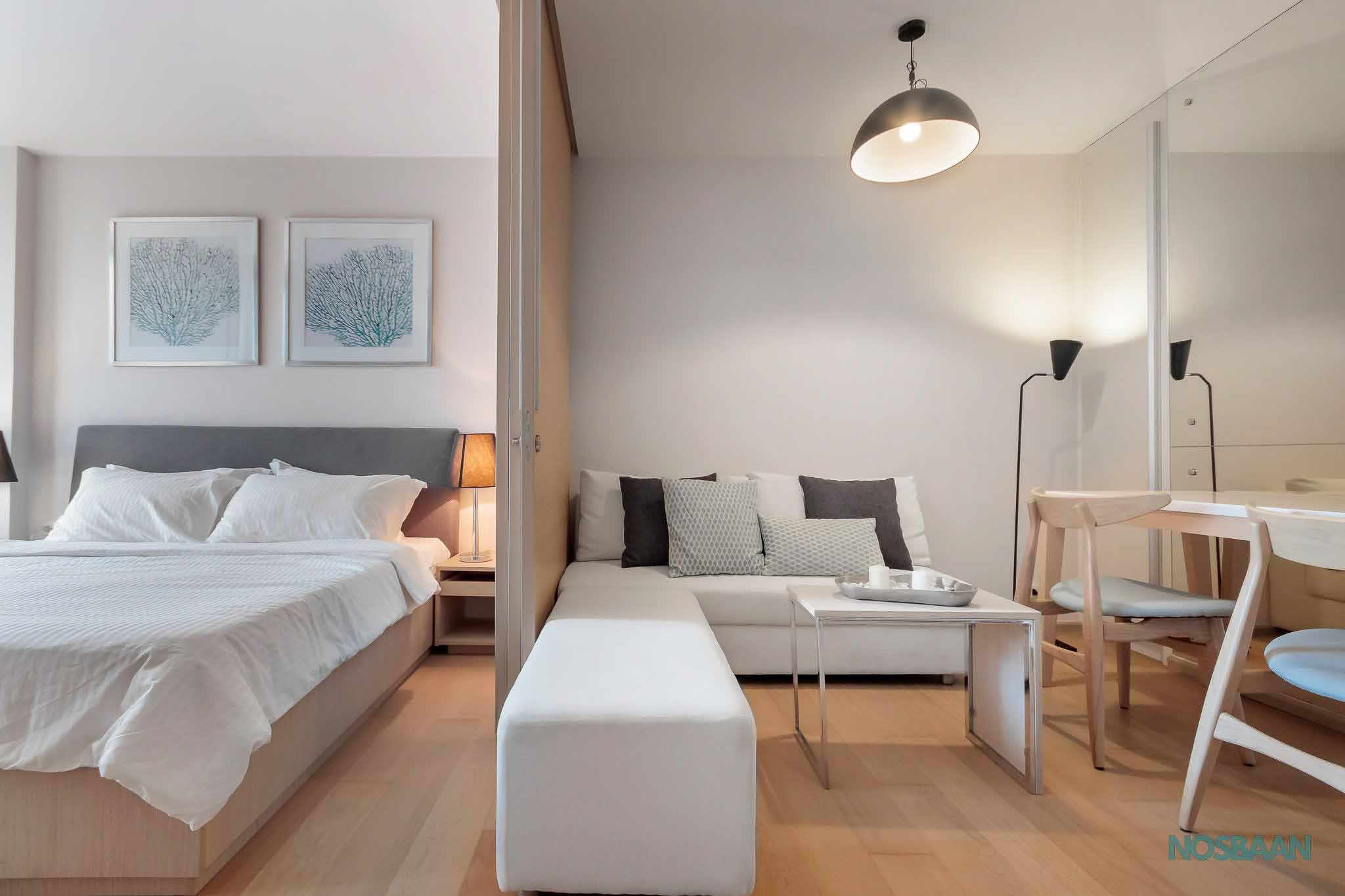 Compact studio unit with smart storage solutions and modern appliances in Ekkamai.