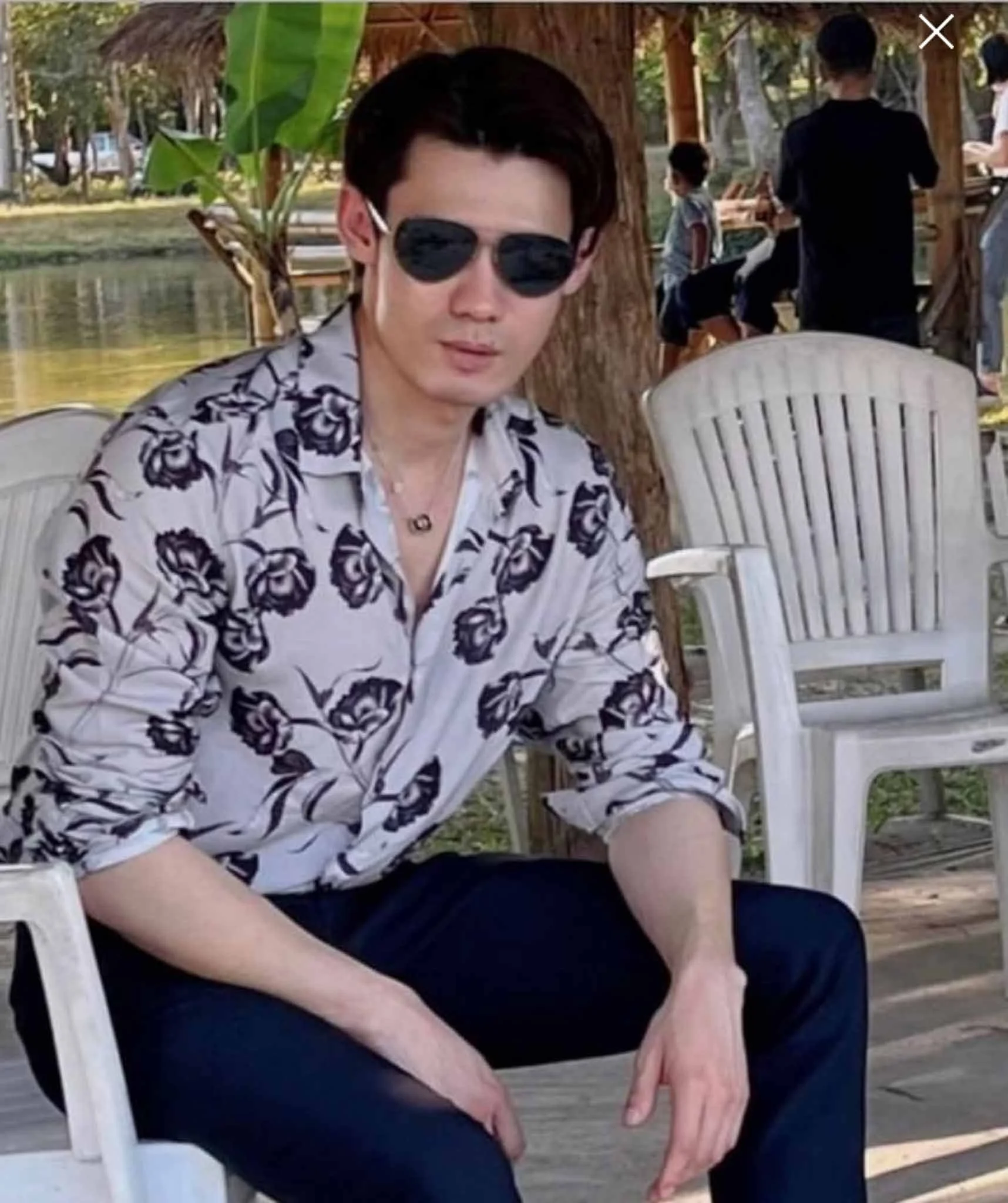 Agent property wearing a floral shirt near to the sea