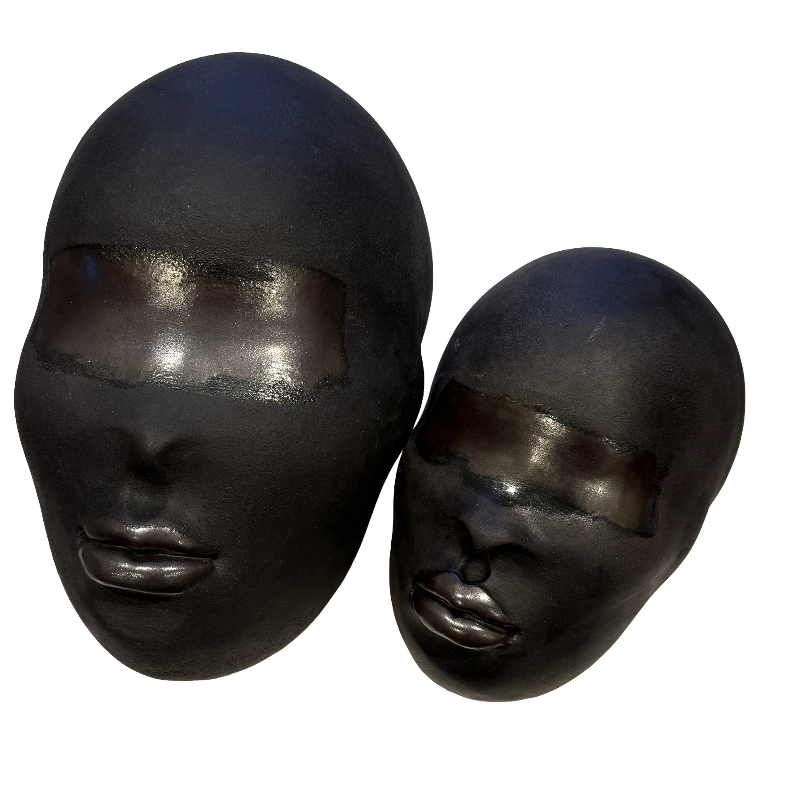 Tawny Phillips - pair of black clay heads.jpeg