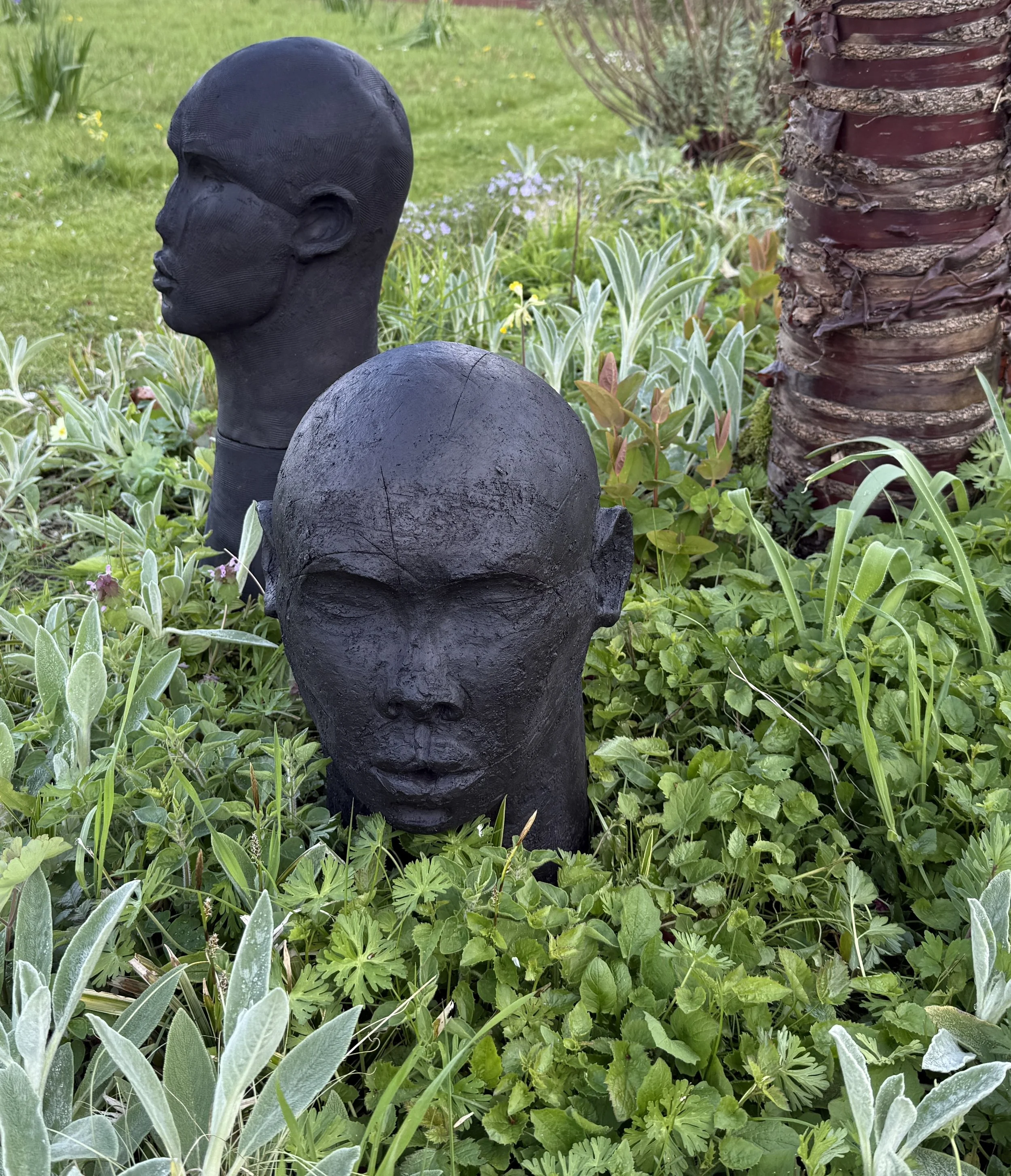 Tawny Phillips - black clay abstract coiled heads.JPG