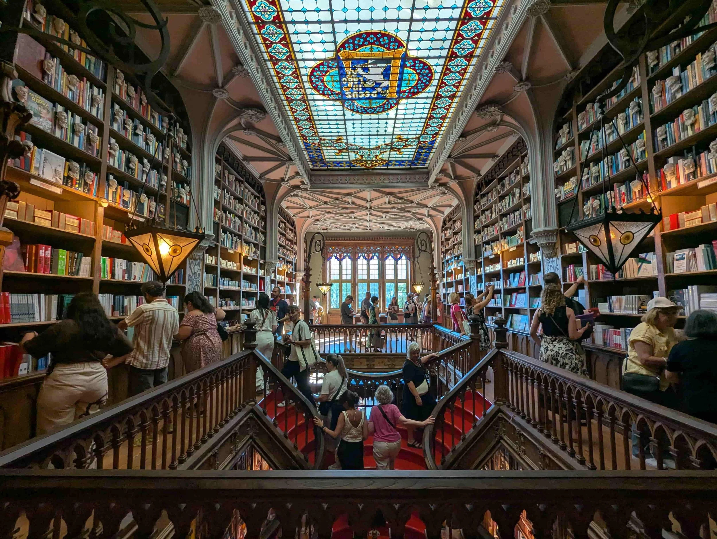 An old bookstore with wooden staircases and tinted glass at Livraria Lello in Porto