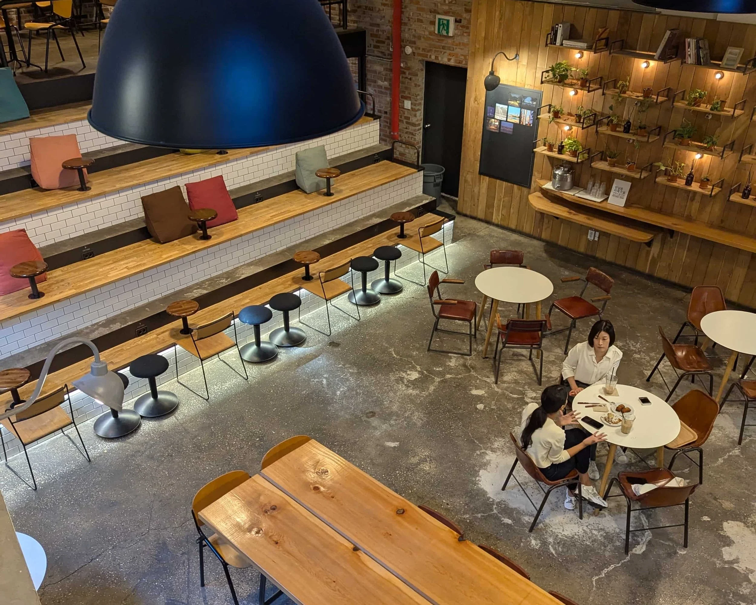 A coffee shop interior with seats and people drinking coffee
