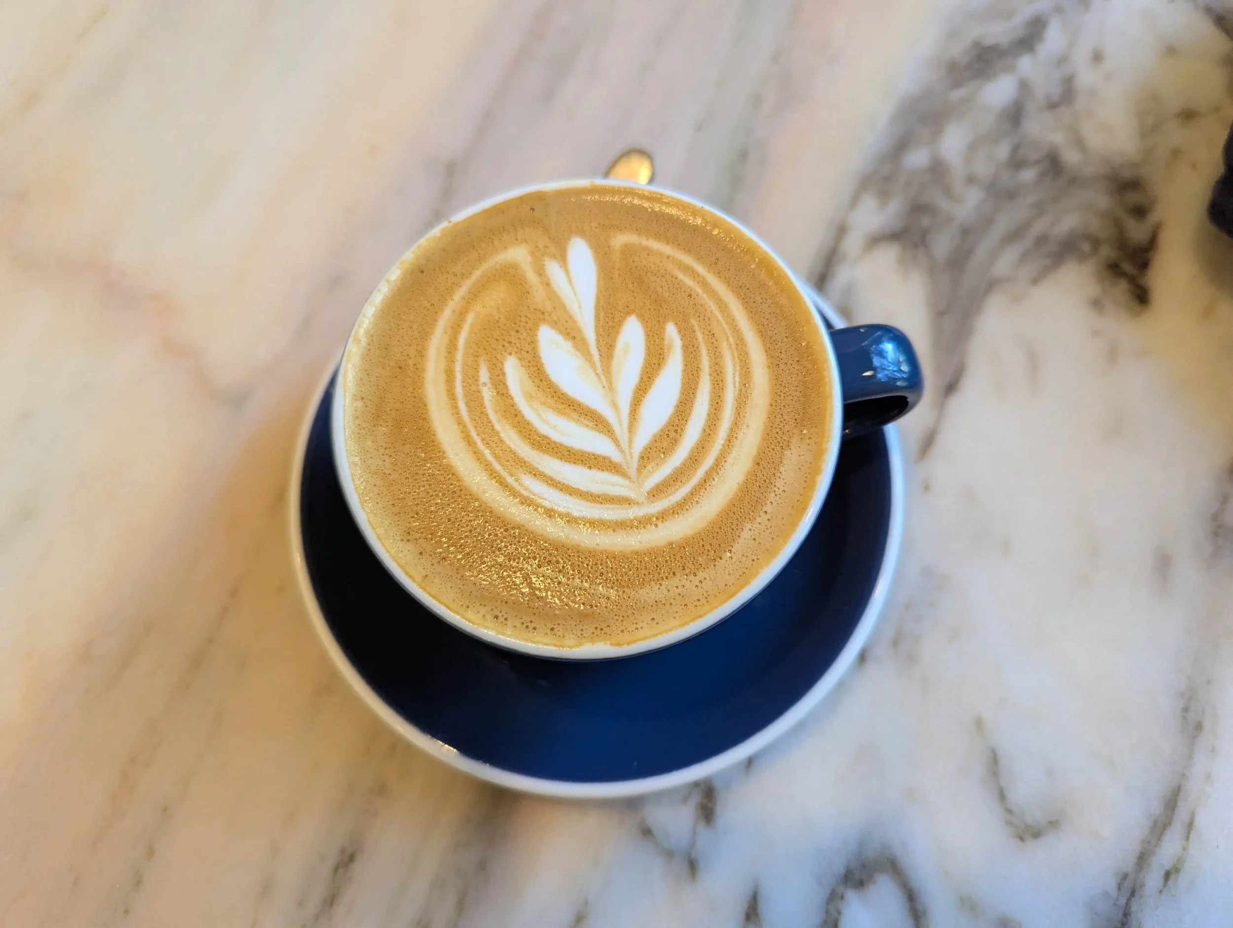 A Flat white on a marble table