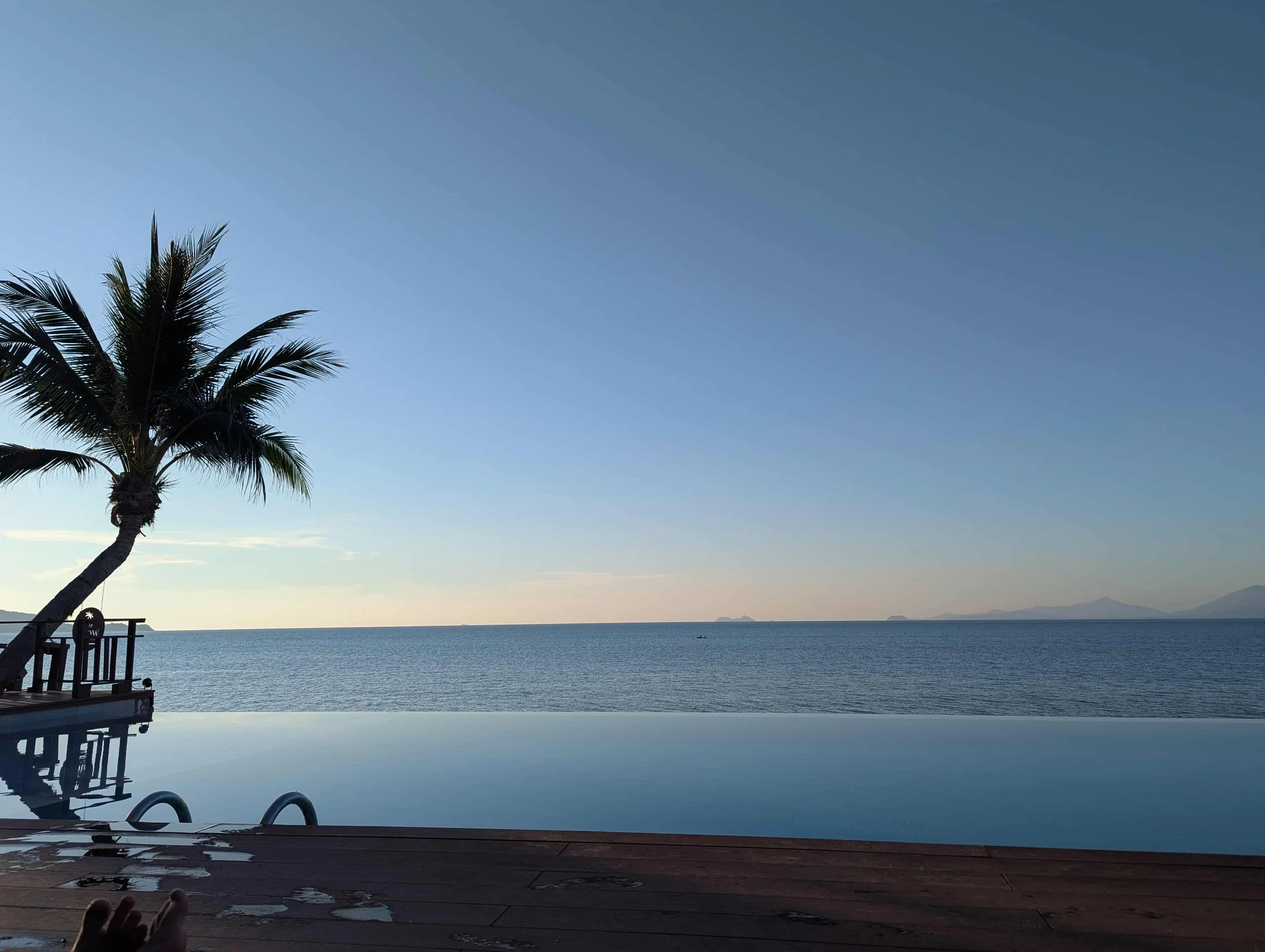 View on a pool and the sea on Koh Samui at sunset