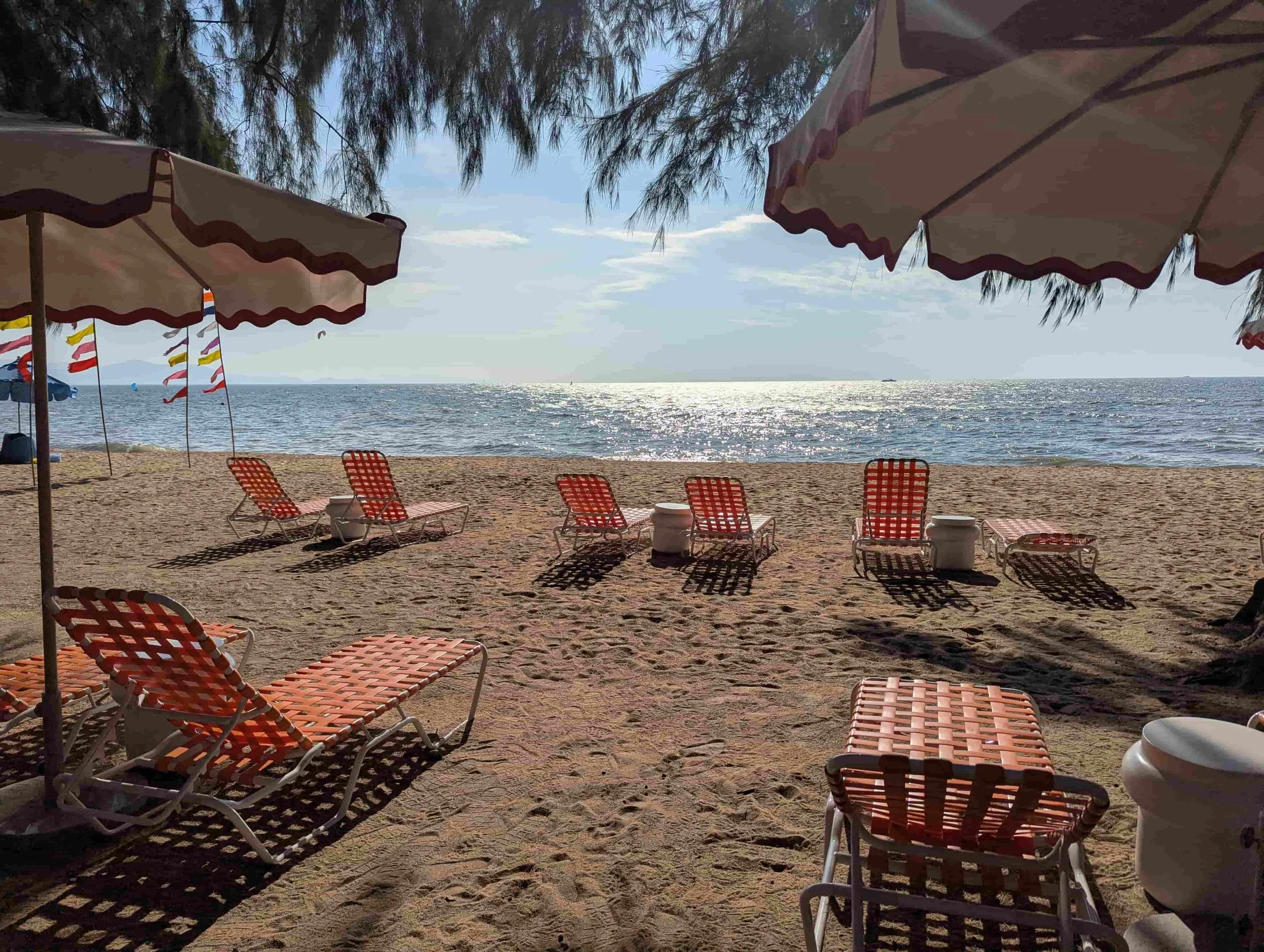 Orange lounge chairs on the beach at The Standard Pattaya