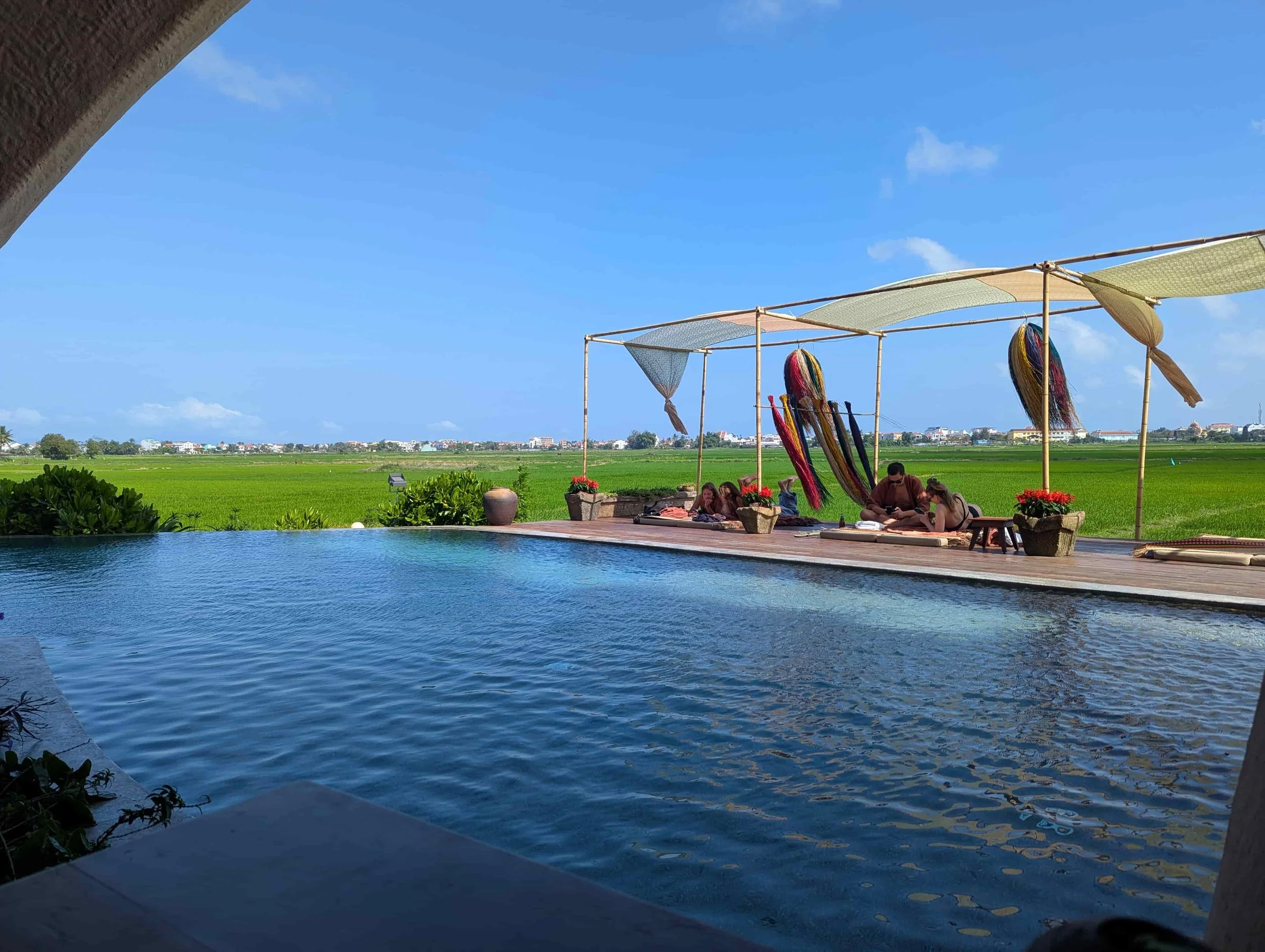 A pool and the rice fields in the background in Hoi An