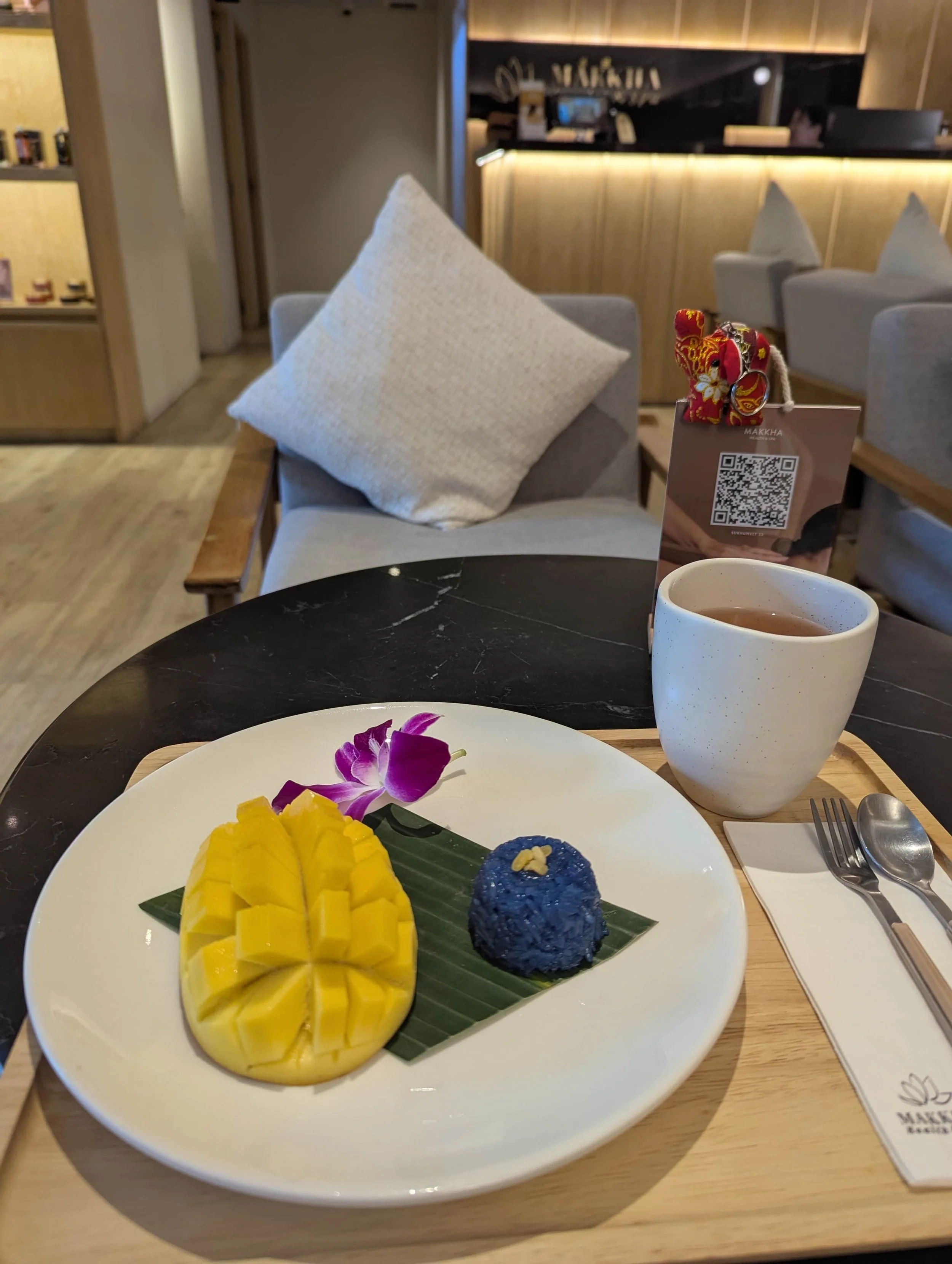 a mango sticky rice on a plate and a tea