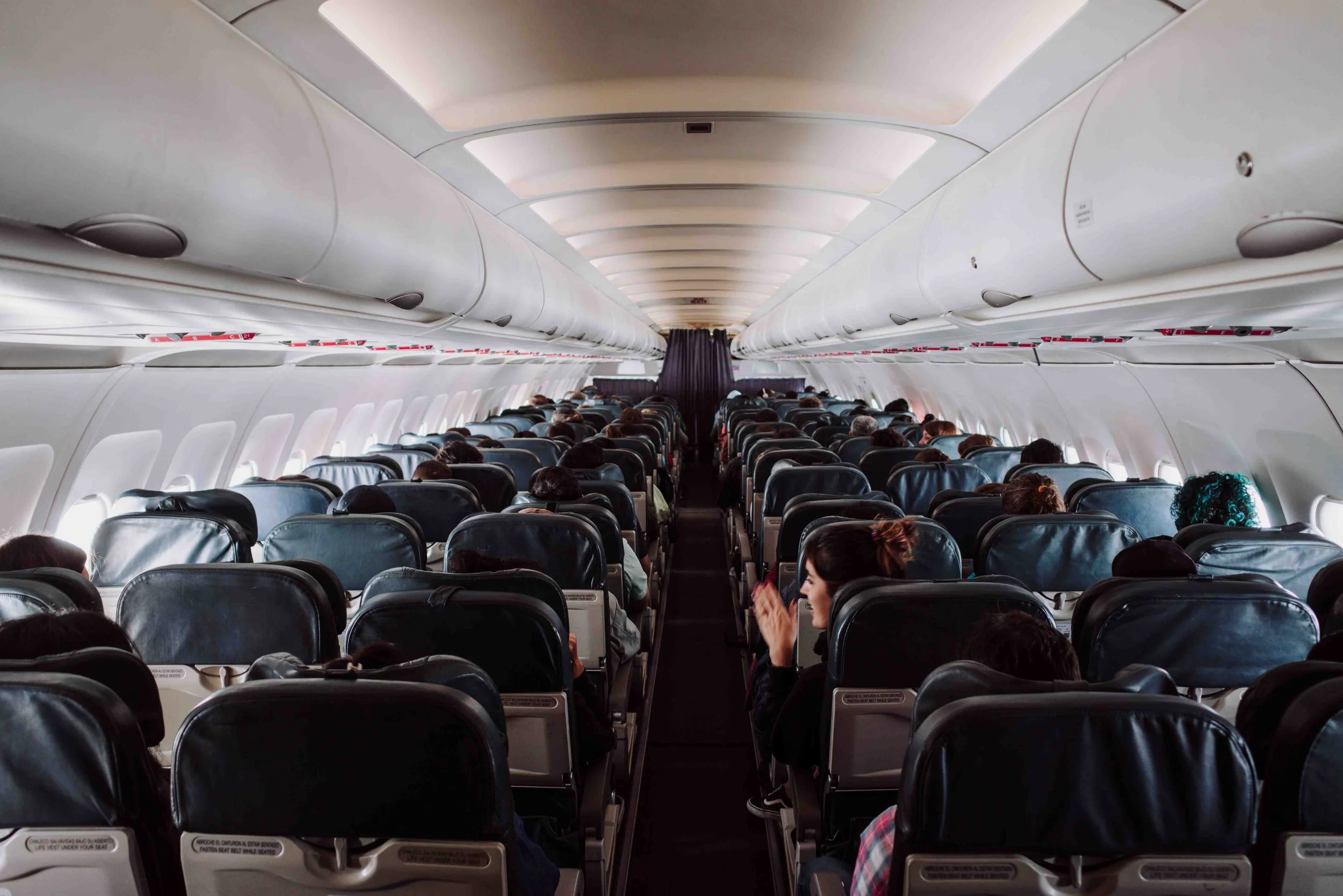 The inside of an airplane filled with people