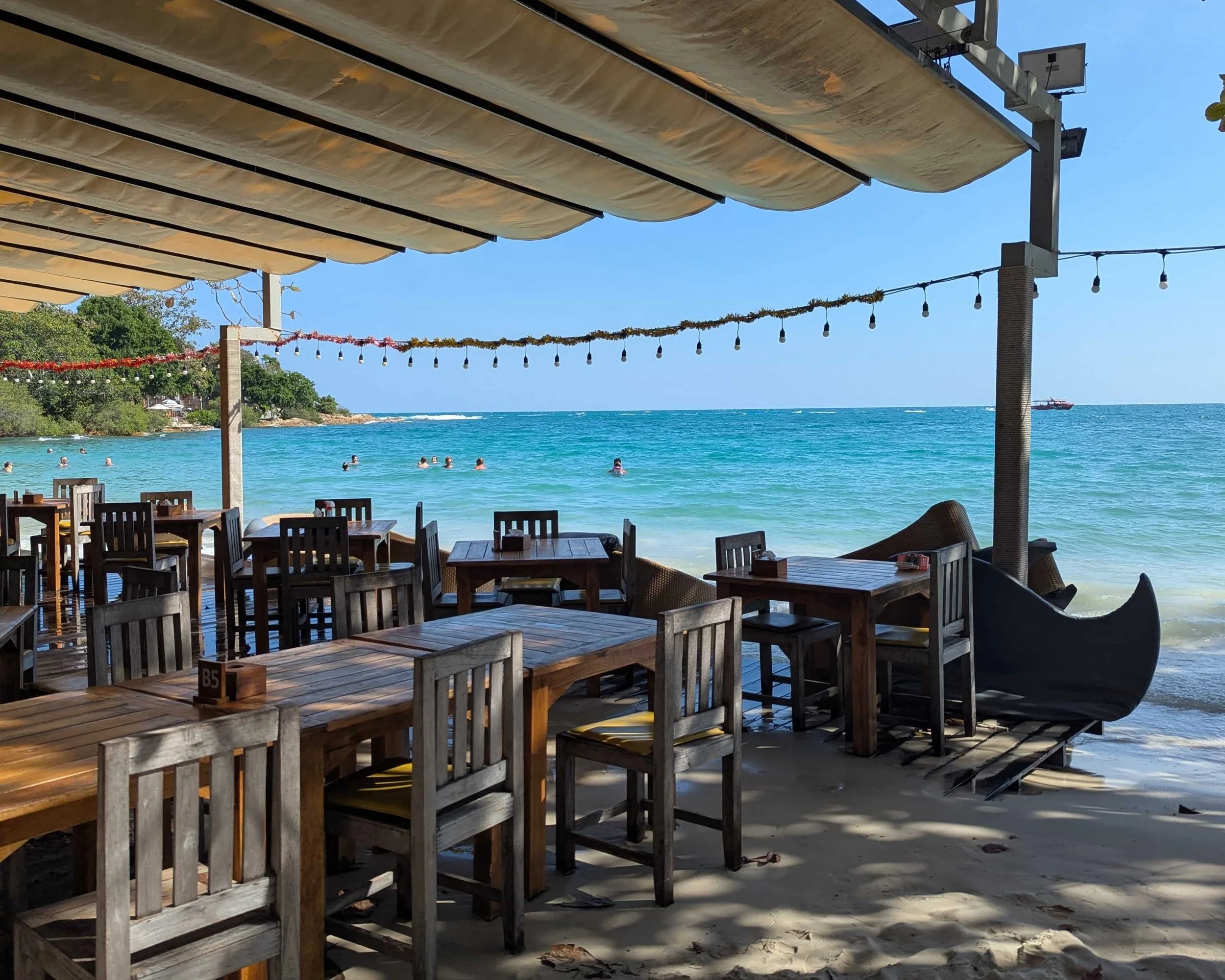 a beach bar with the sea in the distance on Koh Samet
