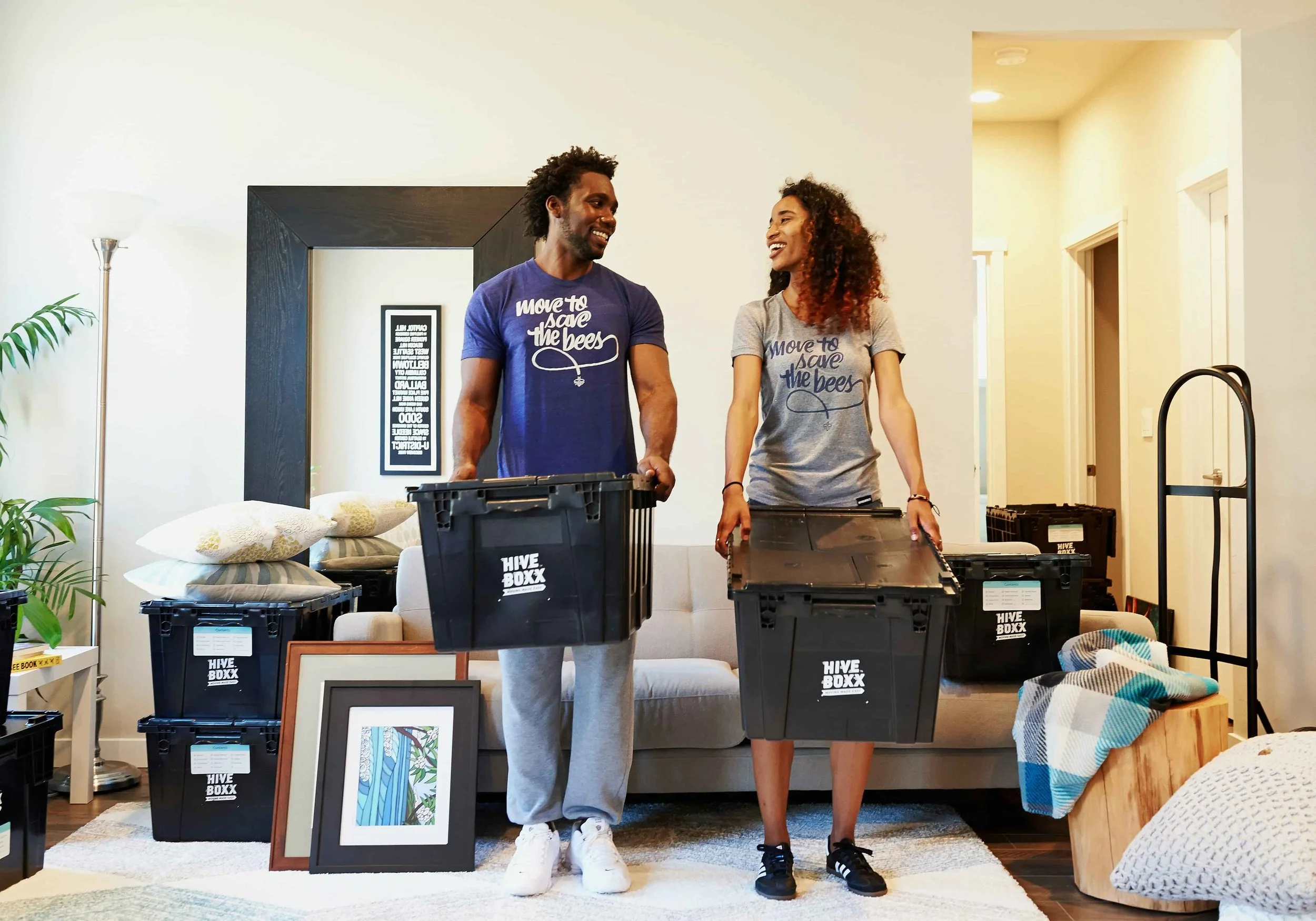 Two people standing in a room with boxes