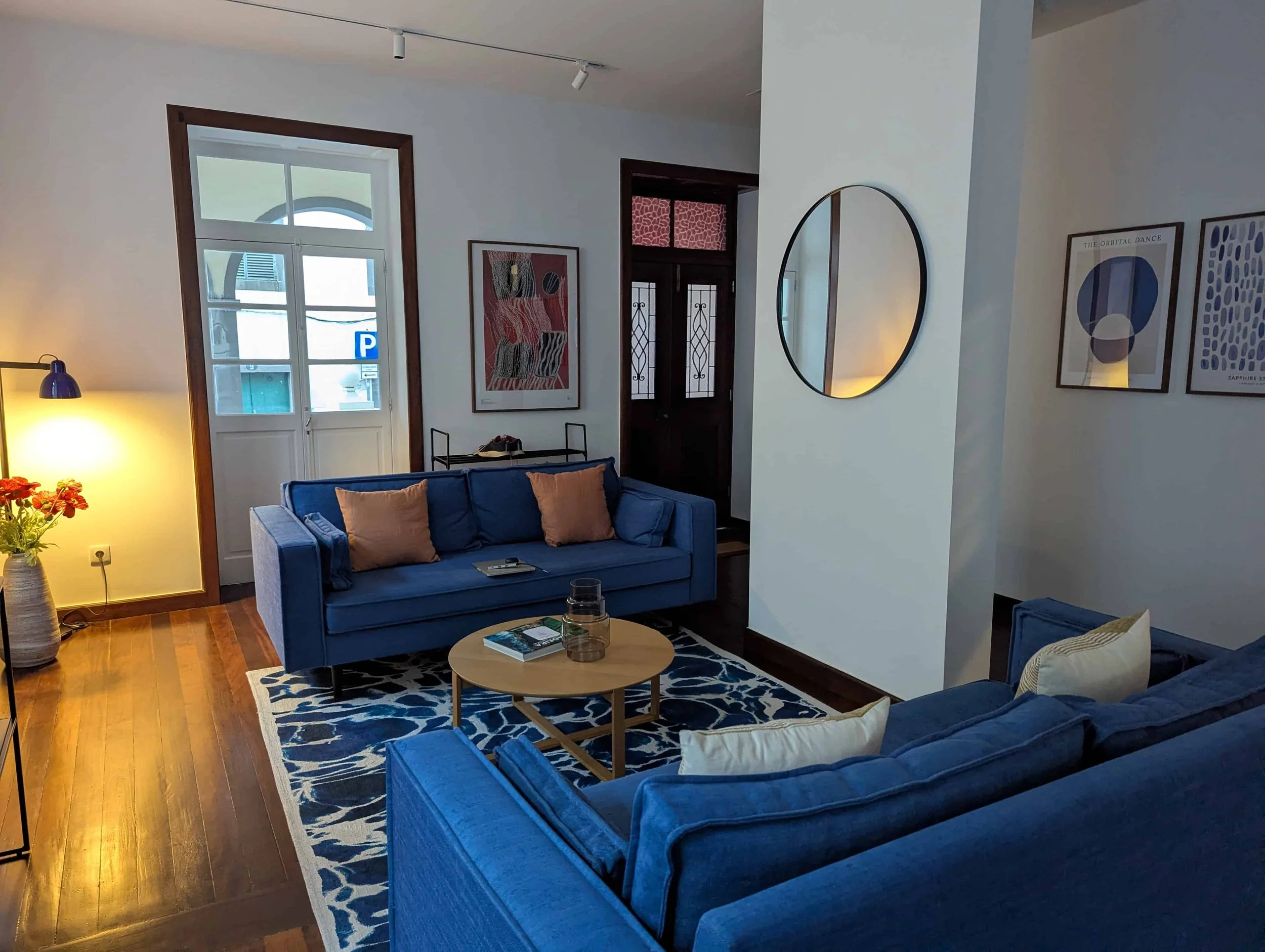 A living room with two blue sofas