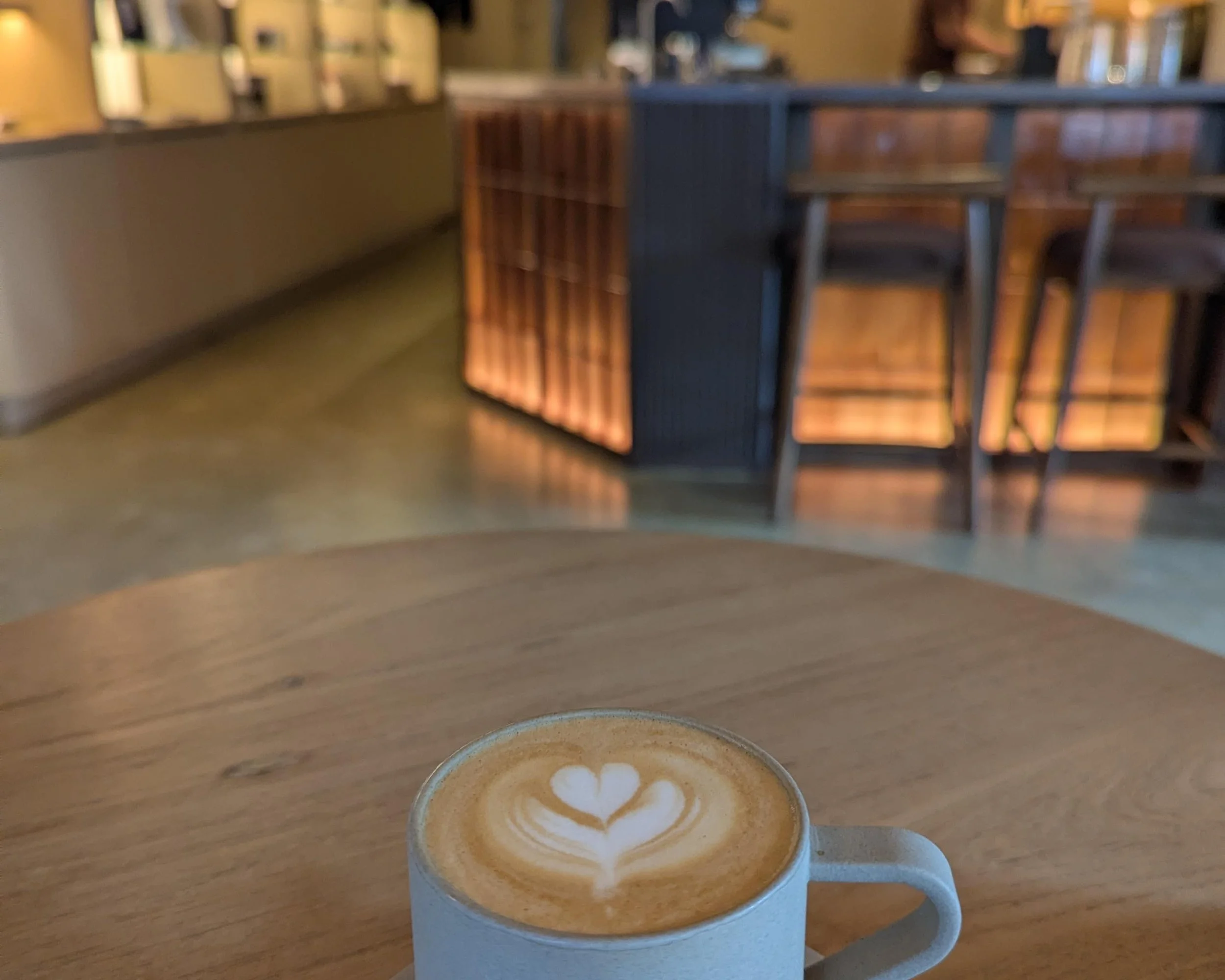 A latte on a wooden table in a cafe
