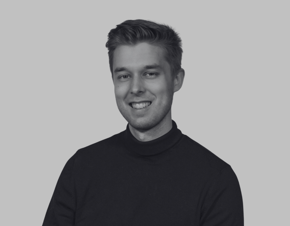 Black-and-white portrait of a young man, against a plain background.