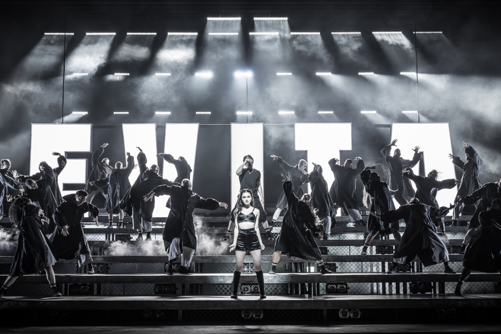 Rachel Zegler as Eva Perón with the cast of Evita