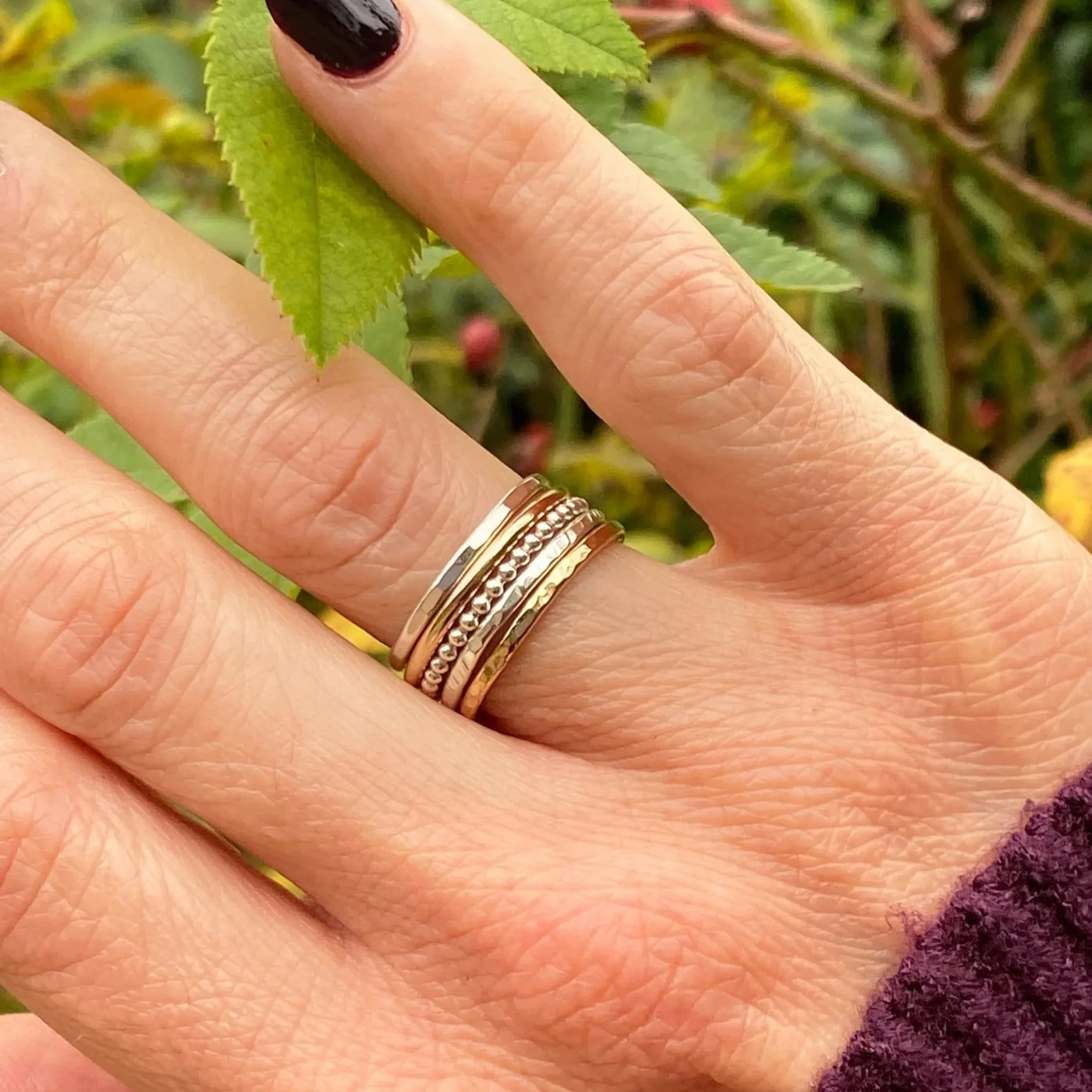 2mm wide 9ct Gold ring, handcrafted by Walter and Nancy Jewellery. Gently textured gold band handmade with love. Shown as part of a mixed metal stack.