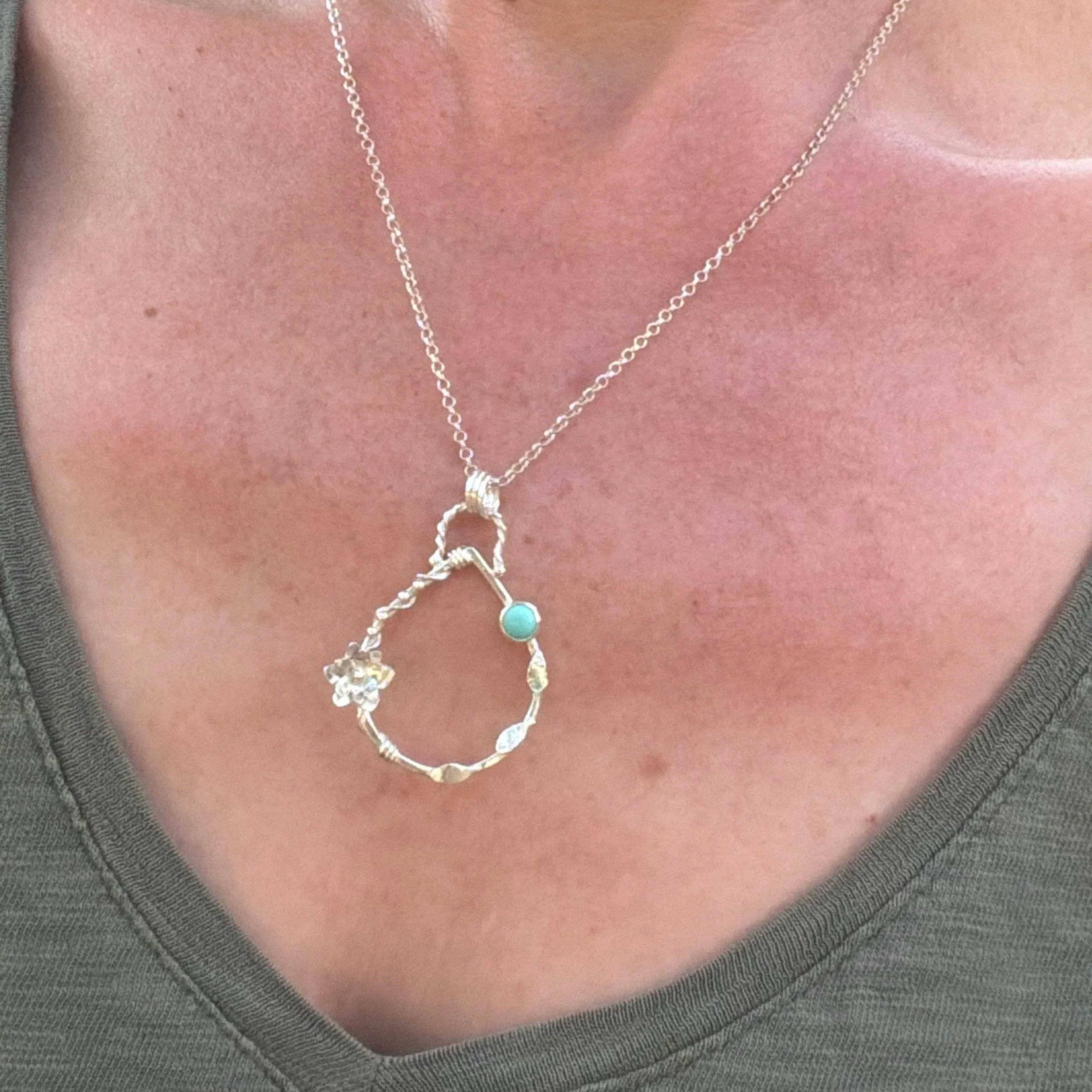 Handcrafted, botanical, sterling silver and turquoise pendant. Handmade by Walter and Nancy Jewellery.