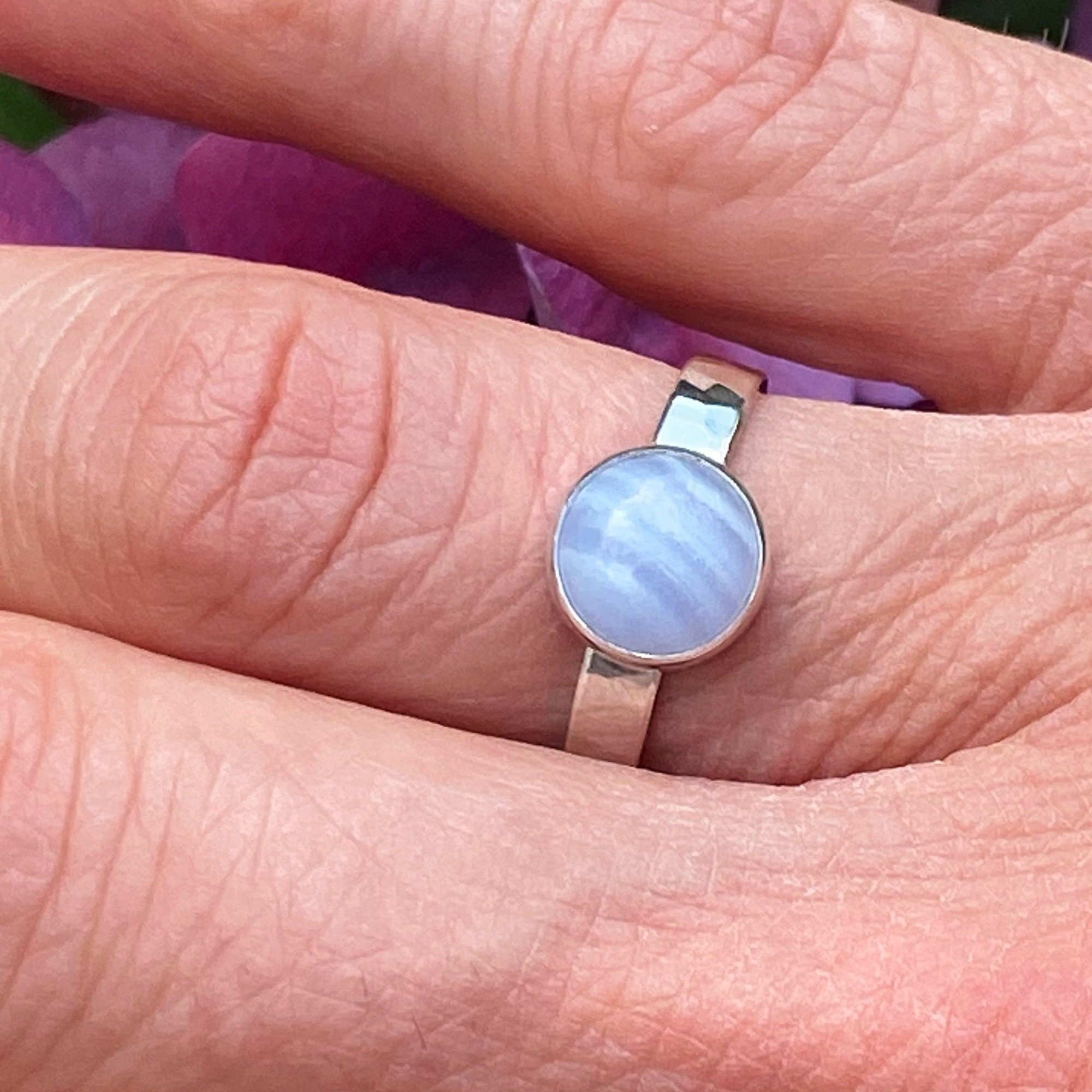 Walter and Nancy Jewellery's handmade, sterling silver and blue lace agate ring shown being worn.