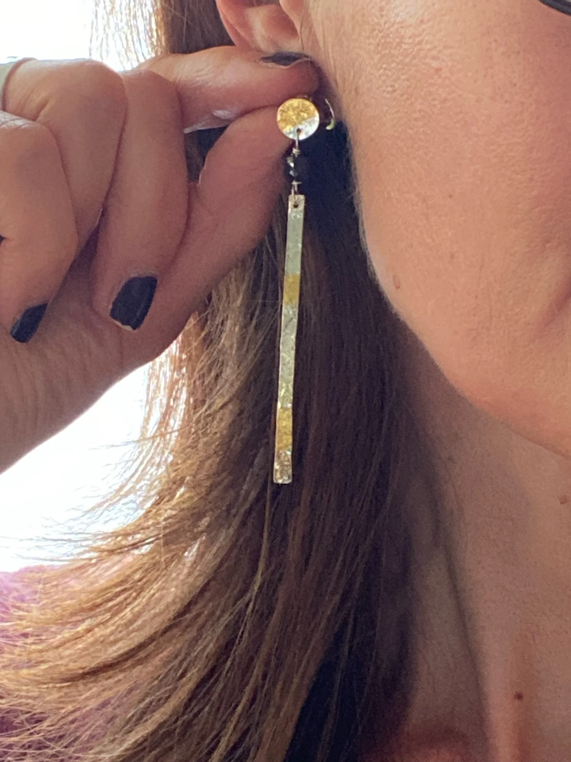 Handmade sterling silver and gold leaf earrings. They feature a black spinel bead to add extra sparkle.