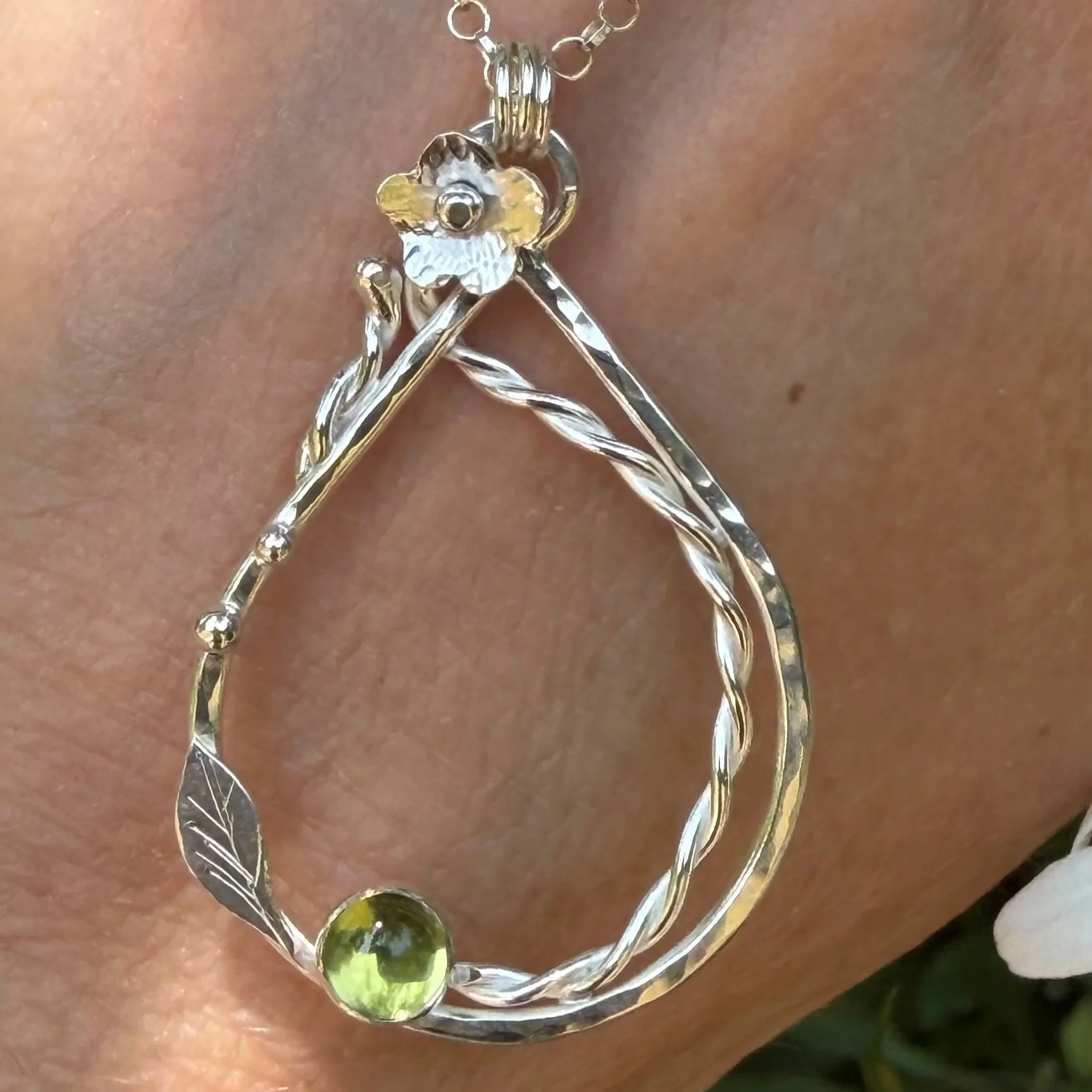 Handcrafted, botanical, sterling silver and peridot pendant. Handmade by Walter and Nancy Jewellery.