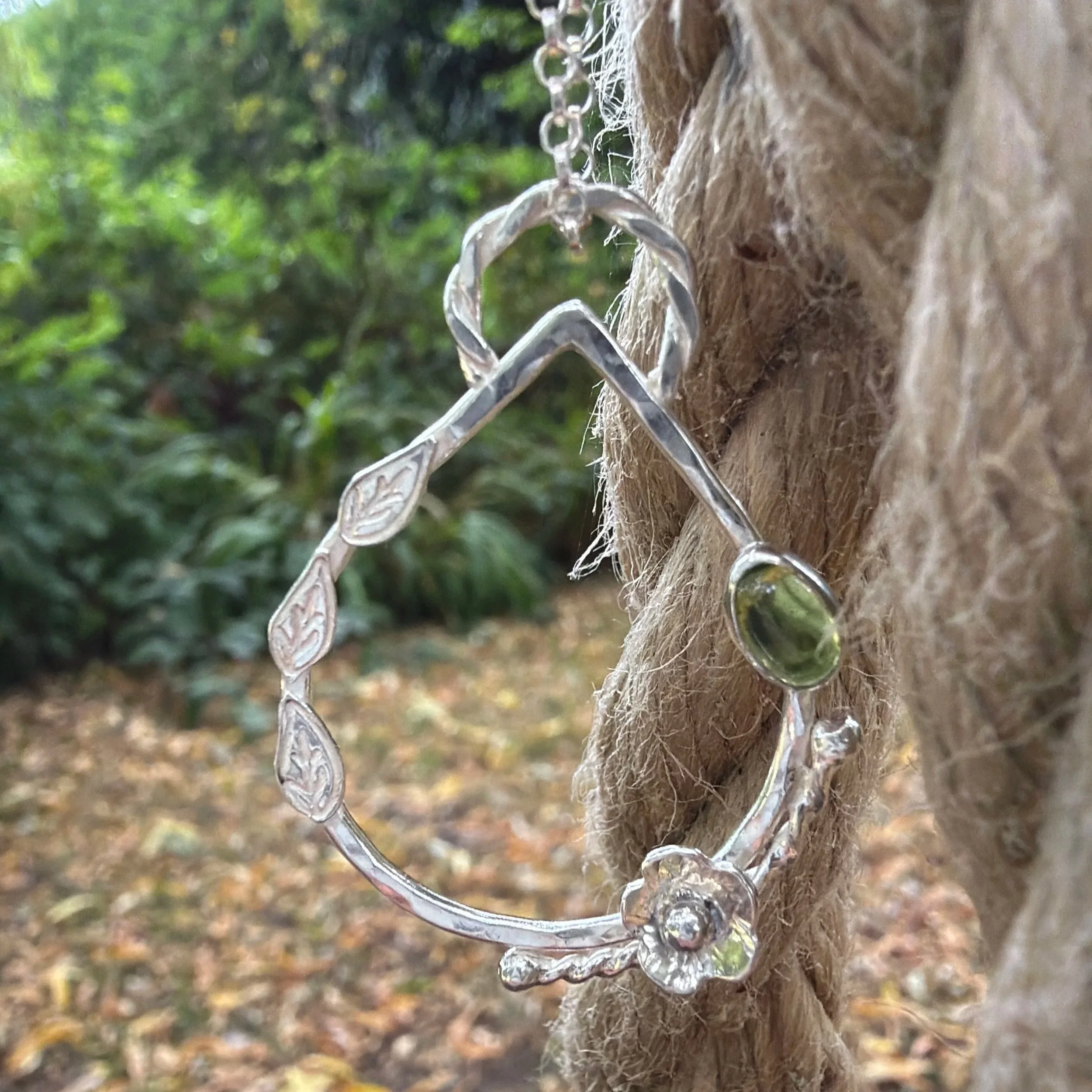 Handcrafted, botanical, sterling silver and peridot pendant. Handmade by Walter and Nancy Jewellery.