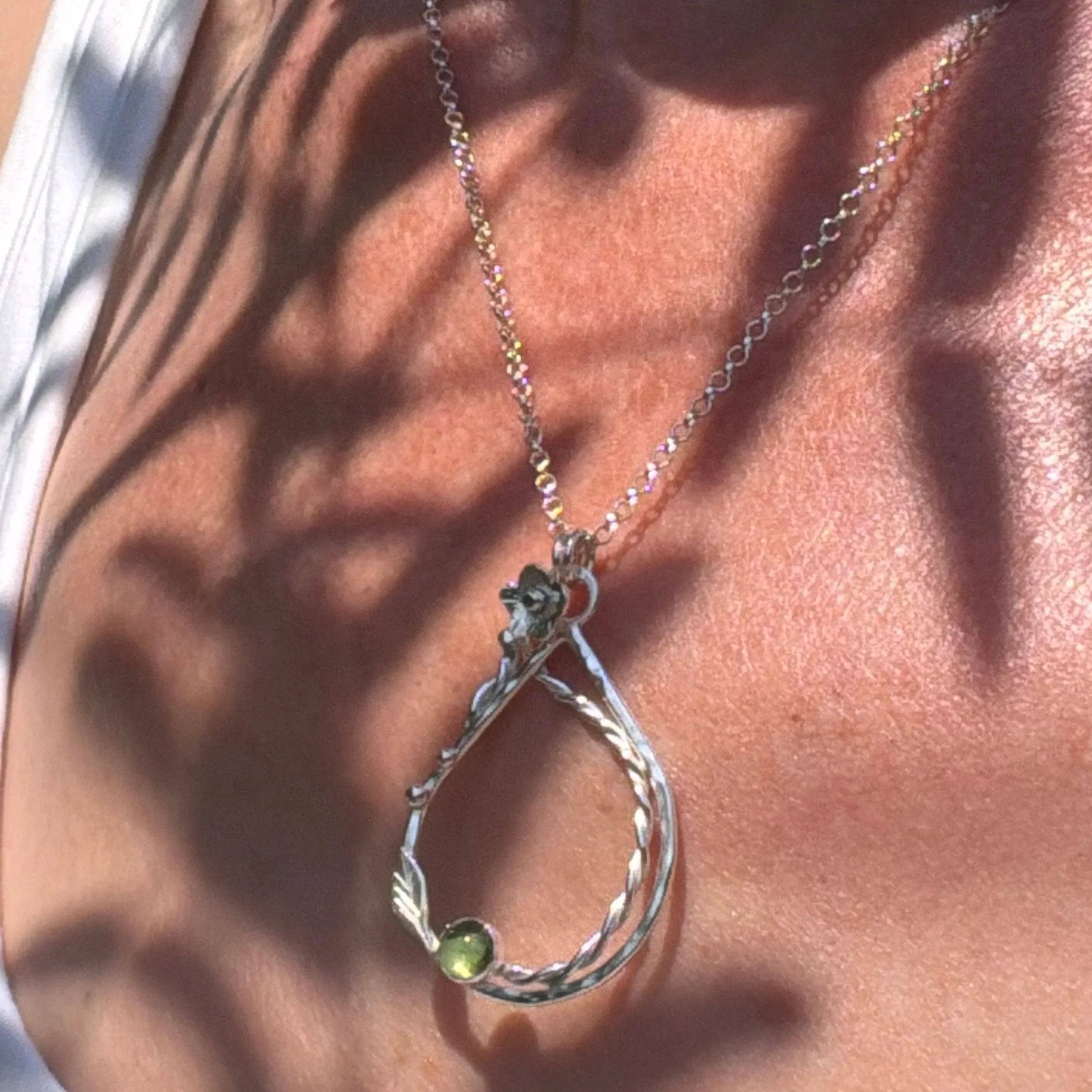 Handcrafted, botanical, sterling silver and peridot pendant. Handmade by Walter and Nancy Jewellery.