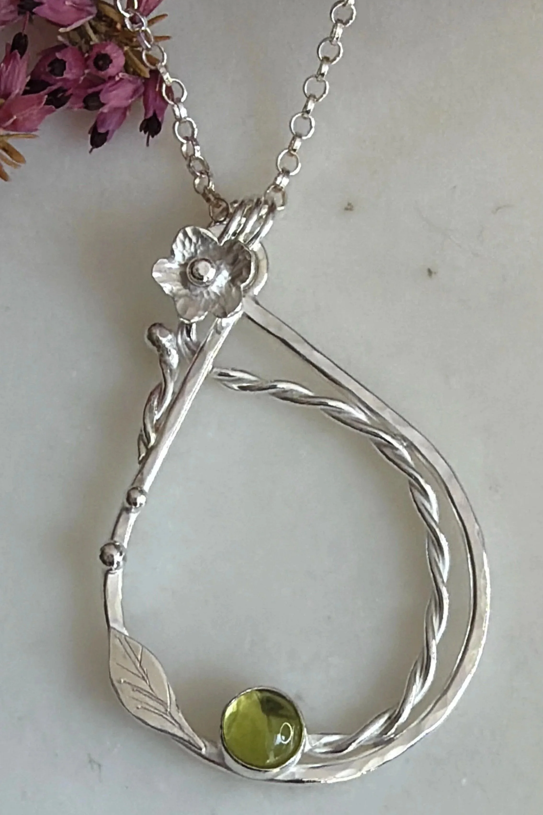Handcrafted, botanical, sterling silver and peridot pendant. Handmade by Walter and Nancy Jewellery.