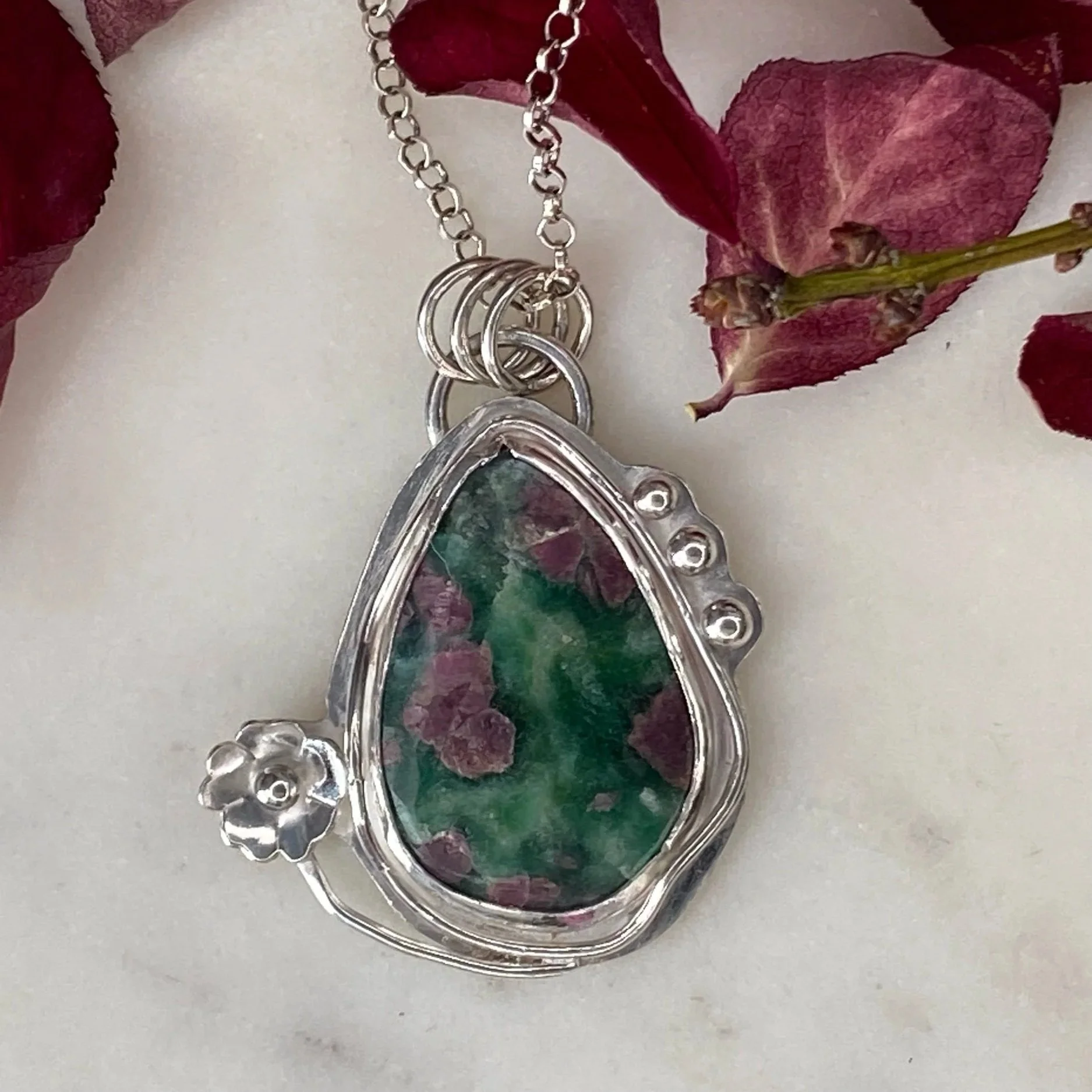 A beautiful Ruby Fuchsite stone set in a handcrafted sterling silver setting. The setting has been hallmarked in London. The piece has been designed and made by Rosie at Walter and Nancy Jewellery.