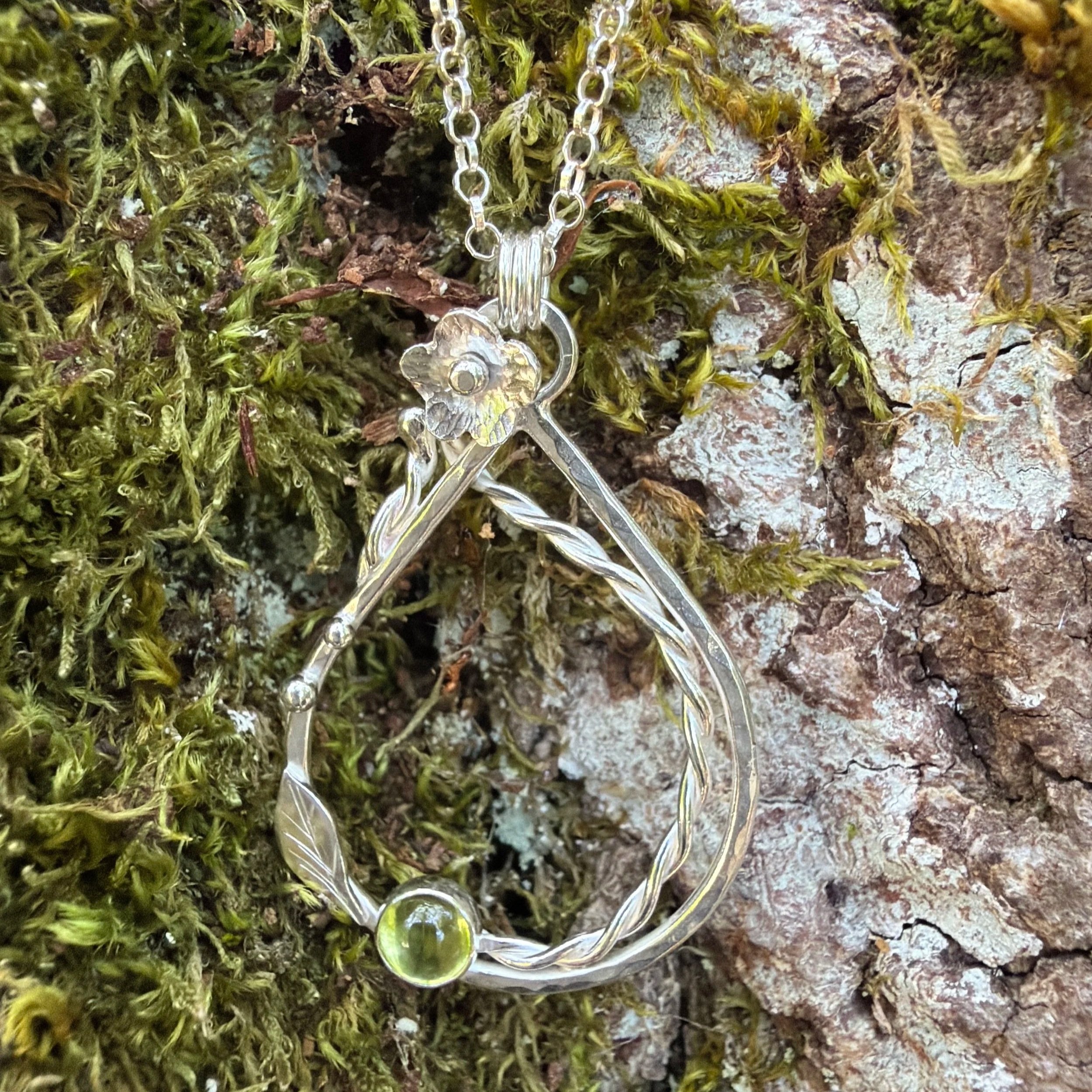 Handcrafted, botanical, sterling silver and peridot pendant. Handmade by Walter and Nancy Jewellery.
