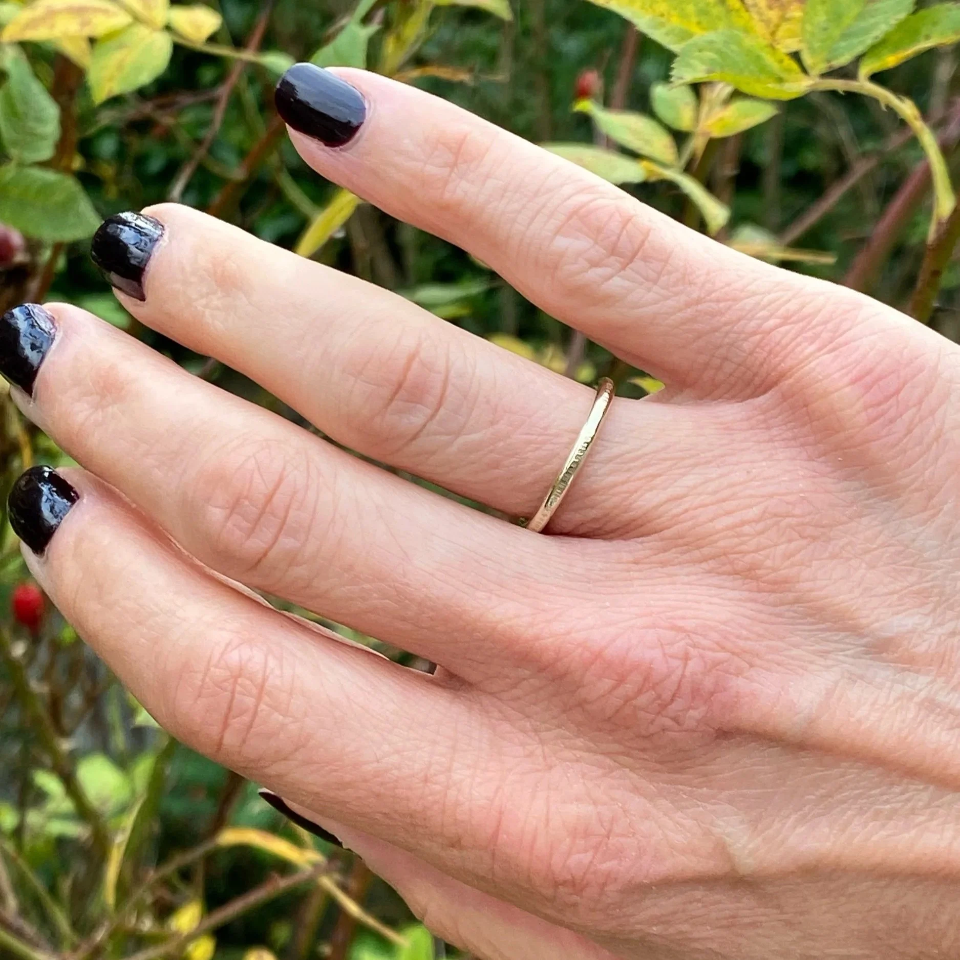 2mm wide 9ct Gold ring, handcrafted by Walter and Nancy Jewellery. Gently textured gold band handmade with love. Shown being worn.