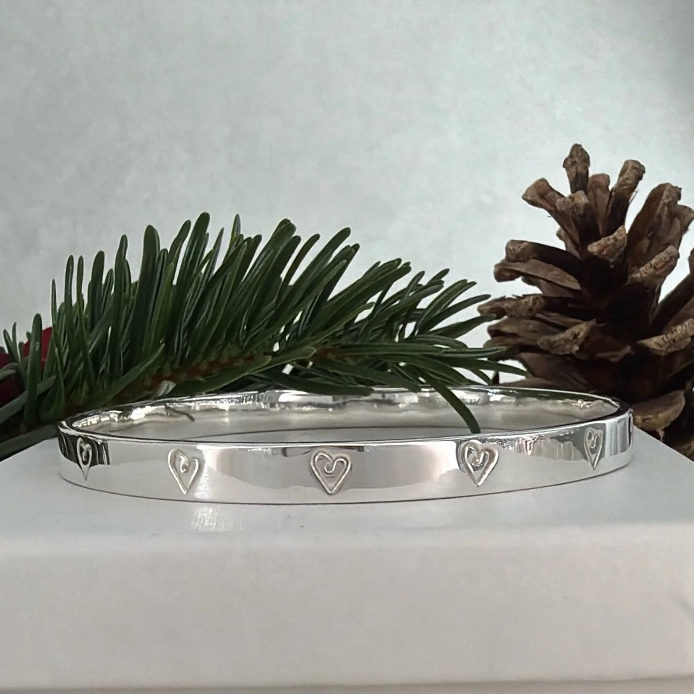 Handmade sterling silver heart bangle.