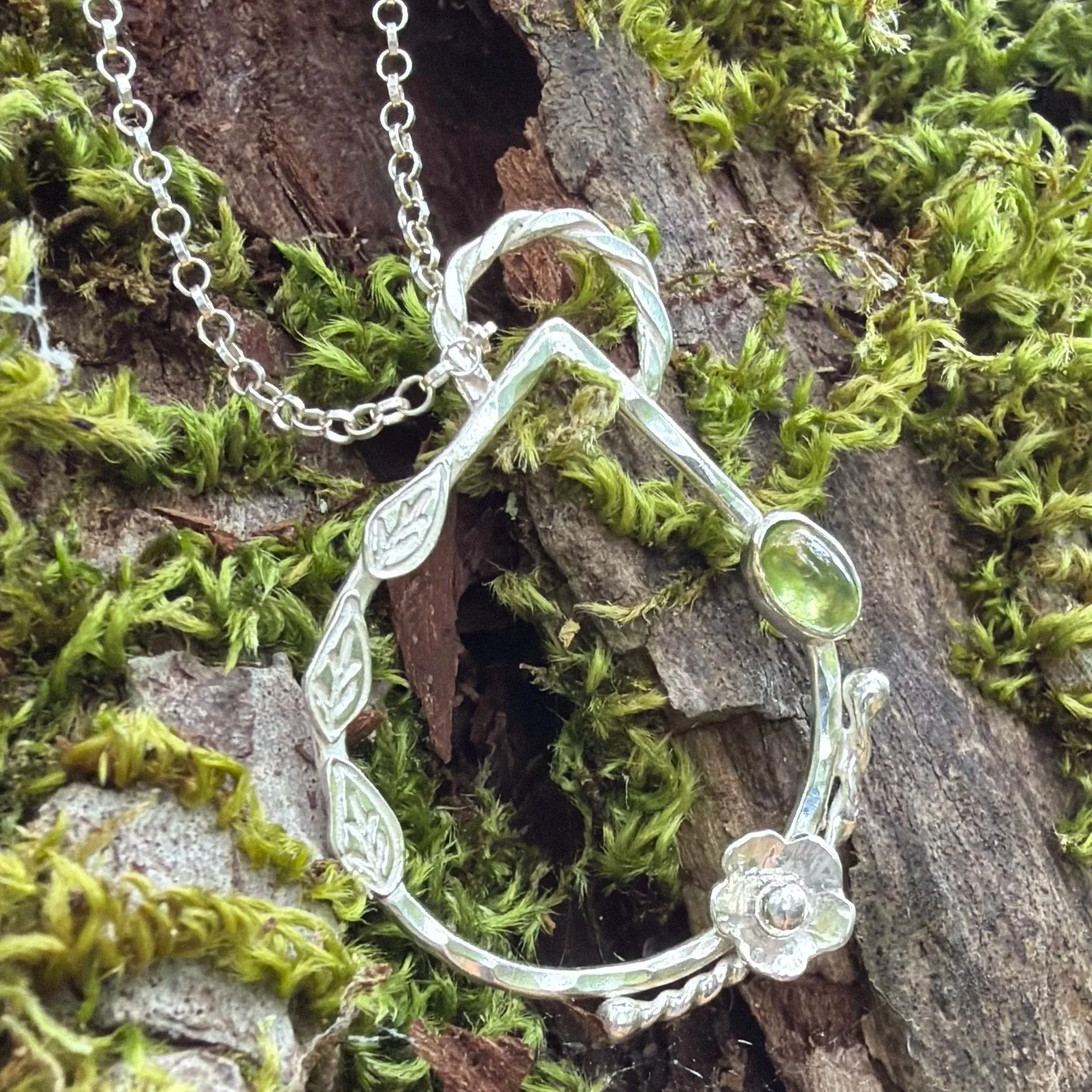 Handcrafted, botanical, sterling silver and peridot pendant. Handmade by Walter and Nancy Jewellery.