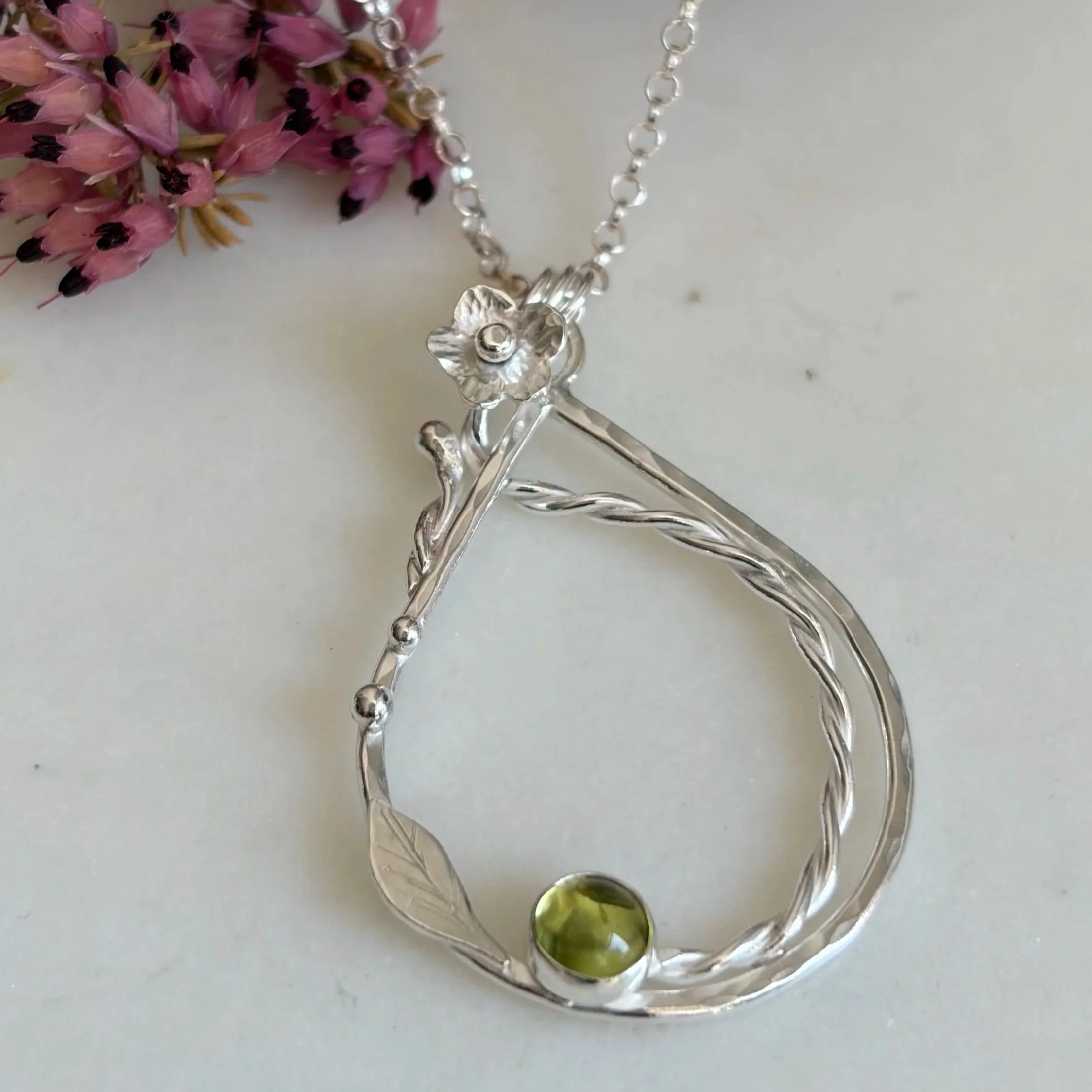 Handcrafted, botanical, sterling silver and peridot pendant. Handmade by Walter and Nancy Jewellery.