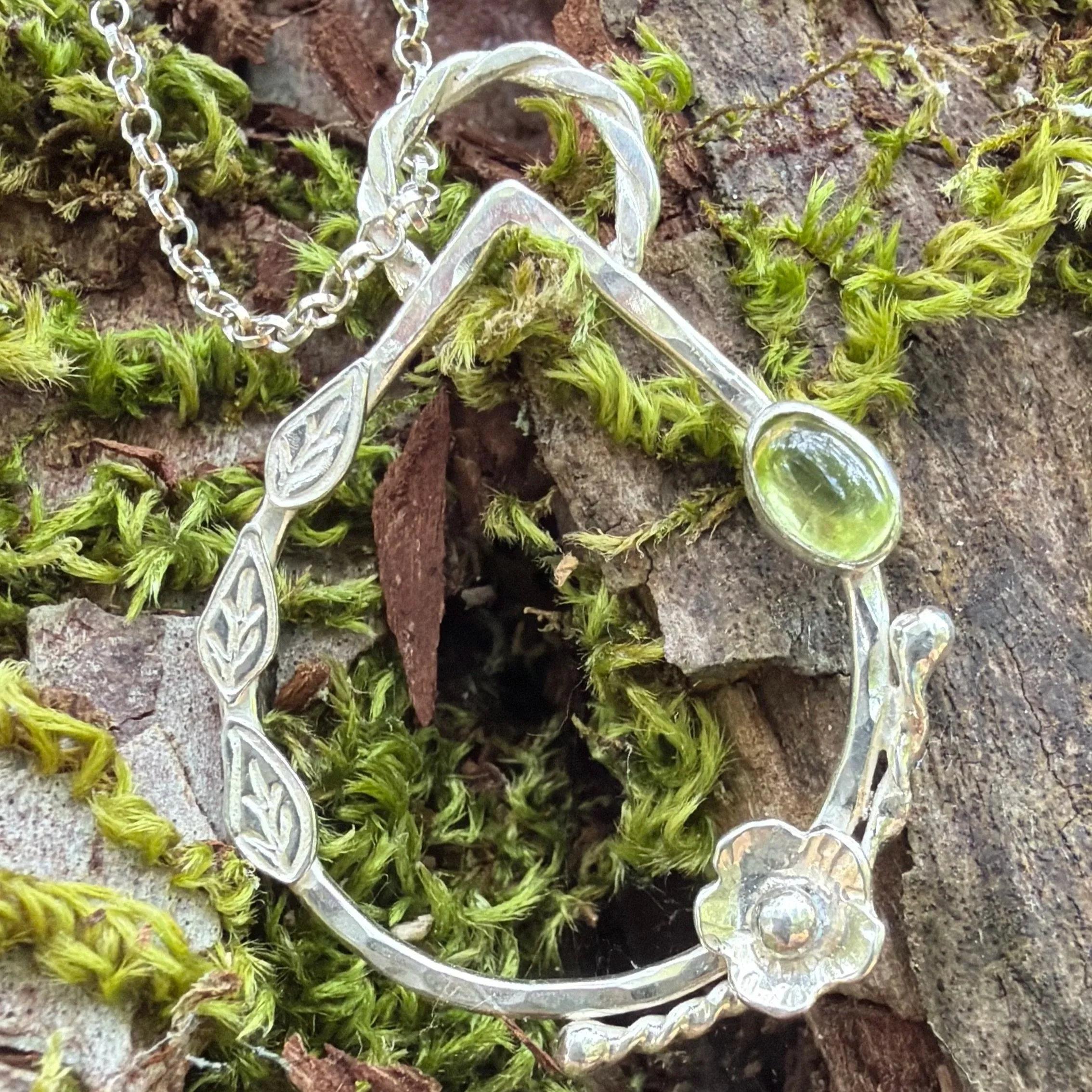 Handcrafted, botanical, sterling silver and peridot pendant. Handmade by Walter and Nancy Jewellery.