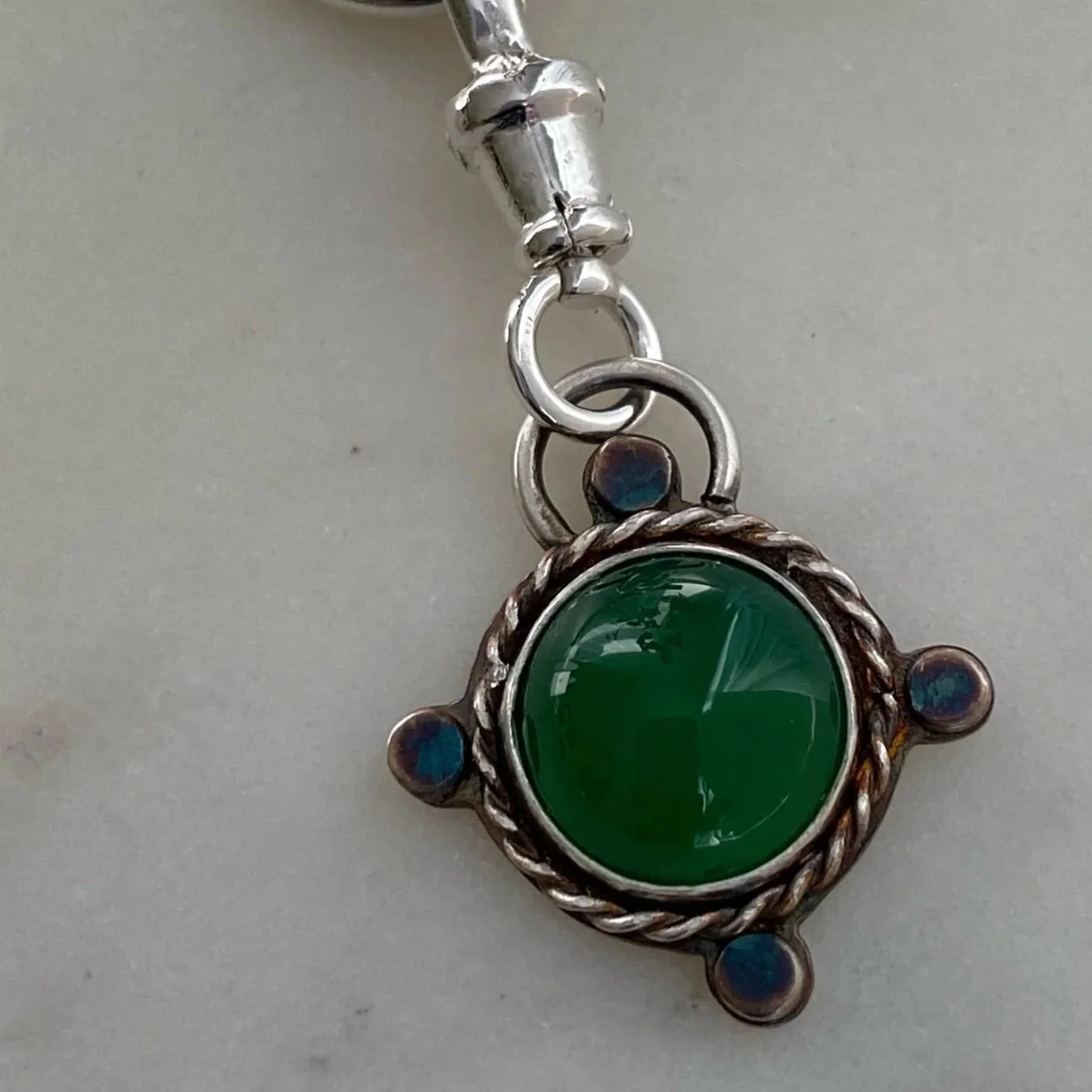 Walter and Nancy Jewellery's handmade, sterling silver and green onyx necklace charm.