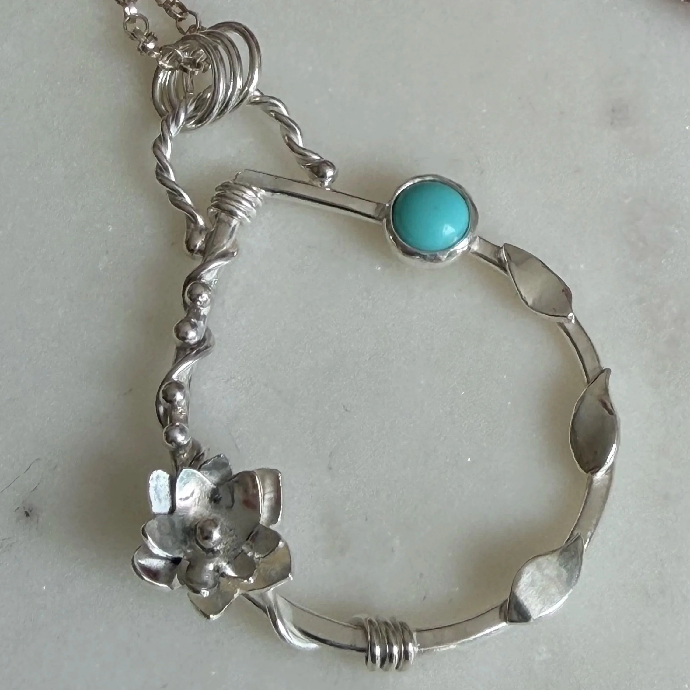 Handcrafted, botanical, sterling silver and turquoise pendant. Handmade by Walter and Nancy Jewellery.IMG_6245.jpg