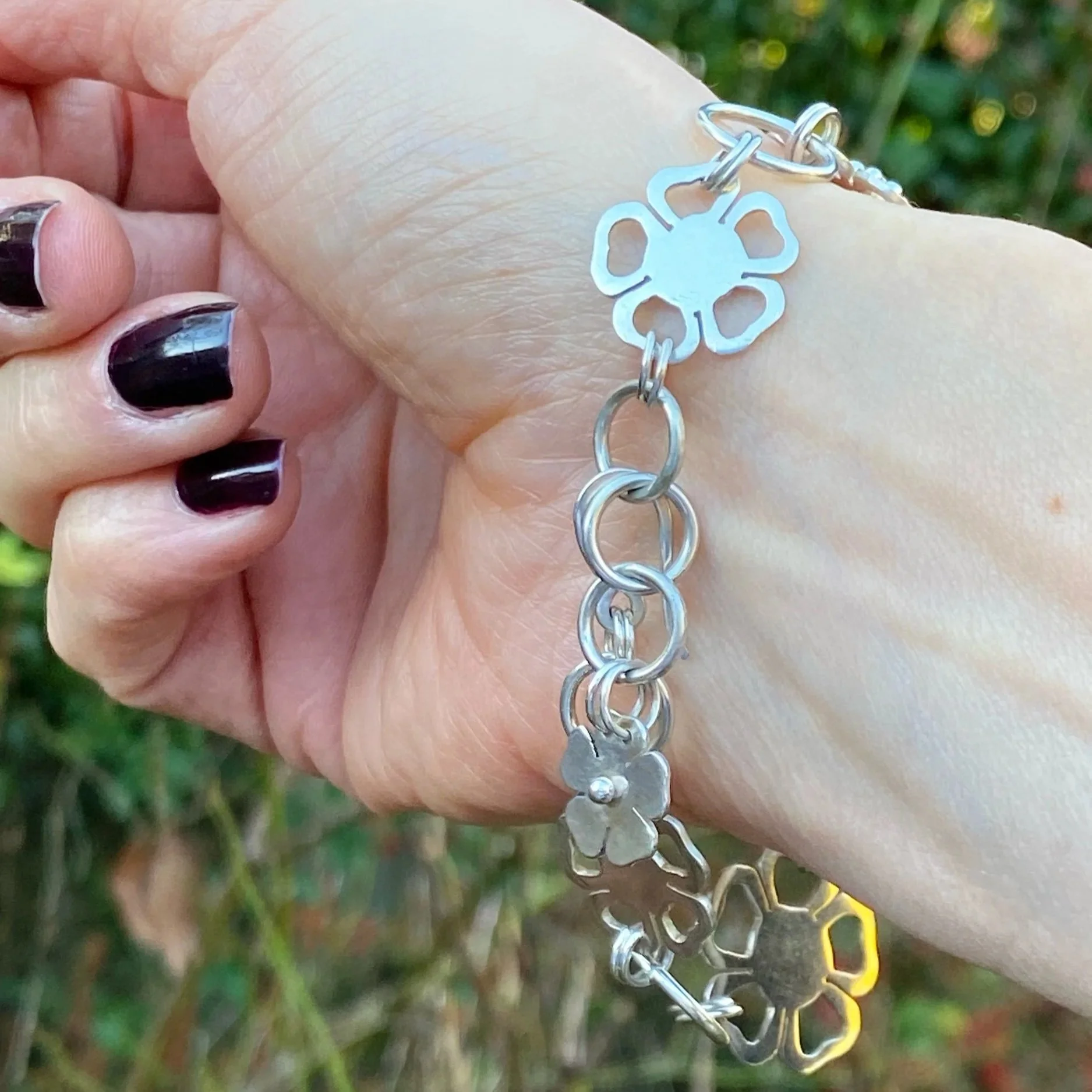 One of a kind, handmade sterling silver and nine carat gold flower bracelet. Made by Walter and Nancy Jewellery.