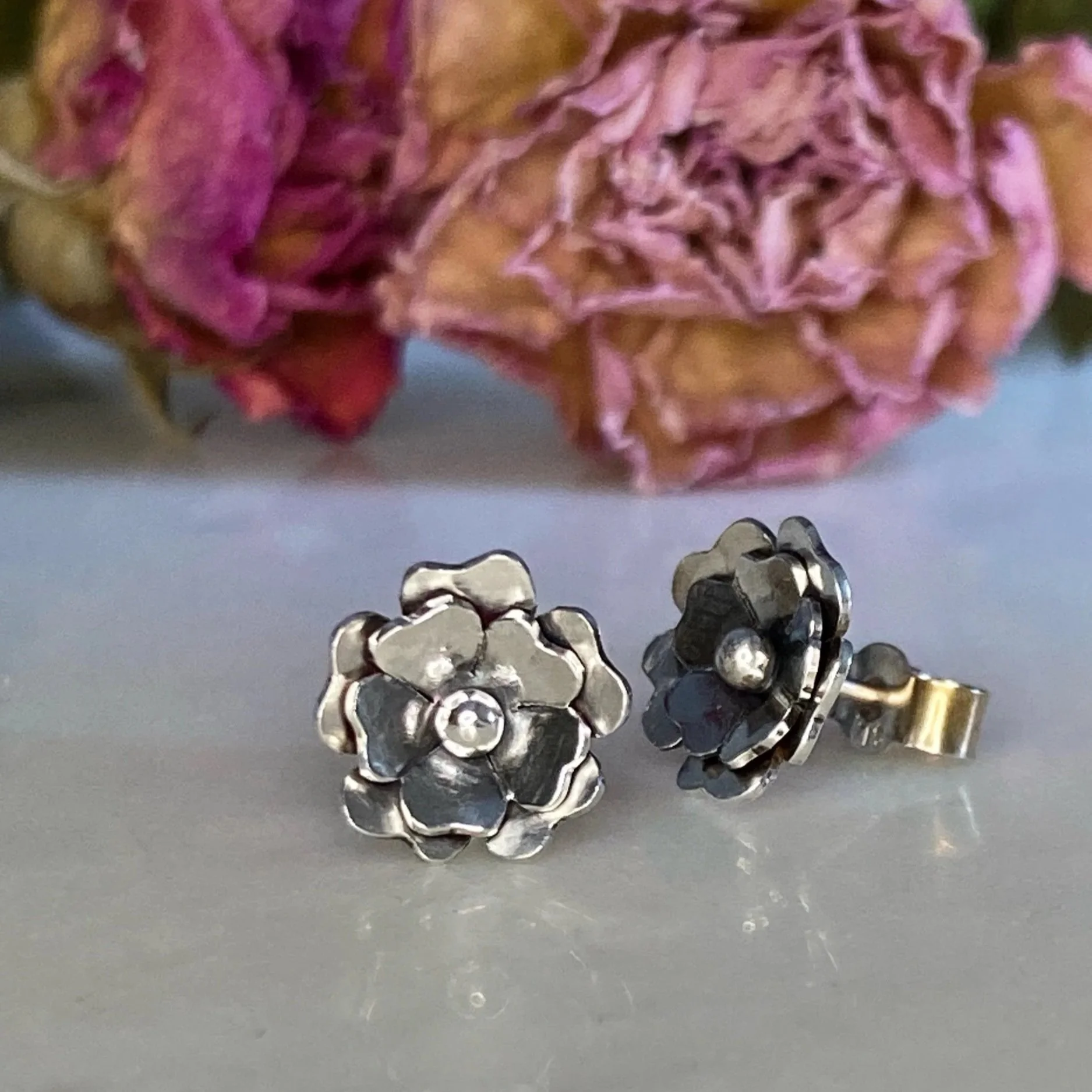 Handmade, sterling silver, flower, stud earrings. Handcrafted by Walter and Nancy Jewellery.