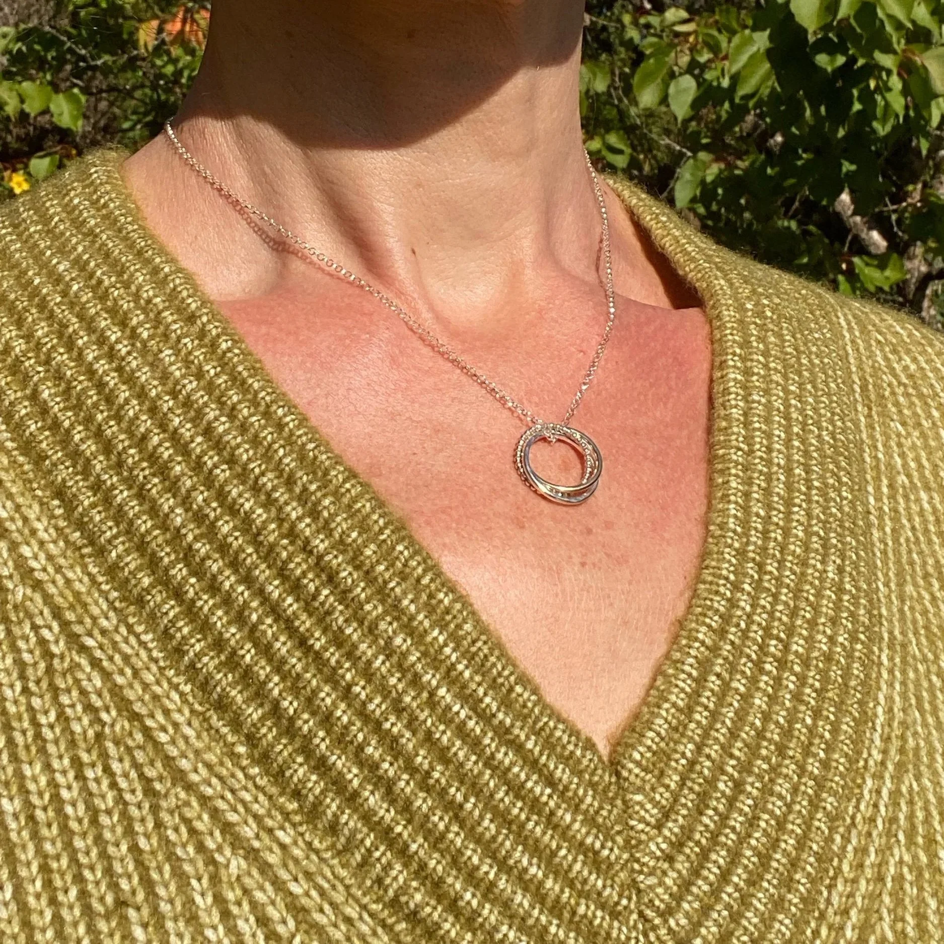 Handcrafted from sterling silver jewellery and 9ct gold by Walter and Nancy Jewellery in Surrey, UK. Three linked rings each with a different finish.