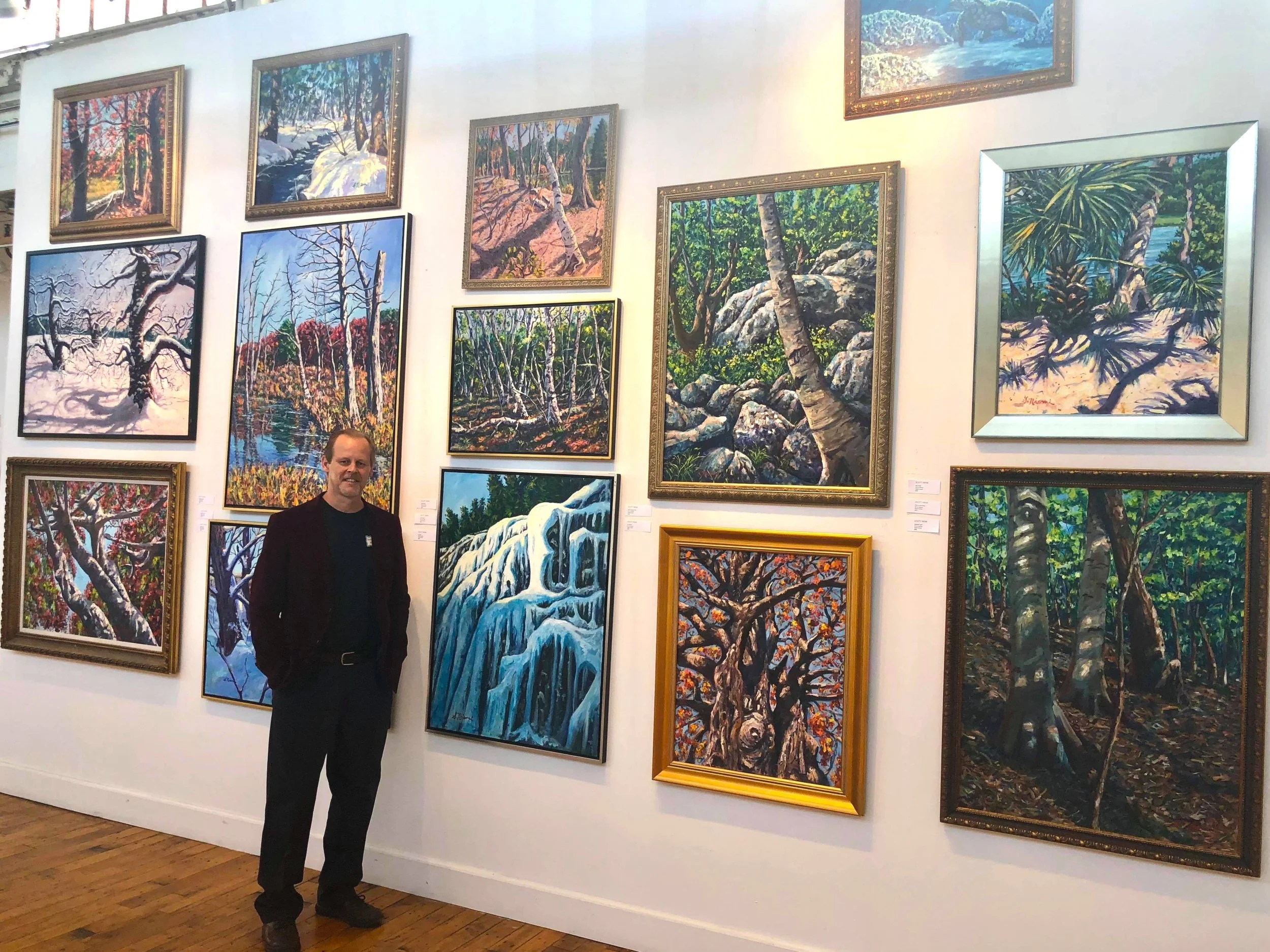SCOTT NIEMI WITH PAINTINGS.jpg